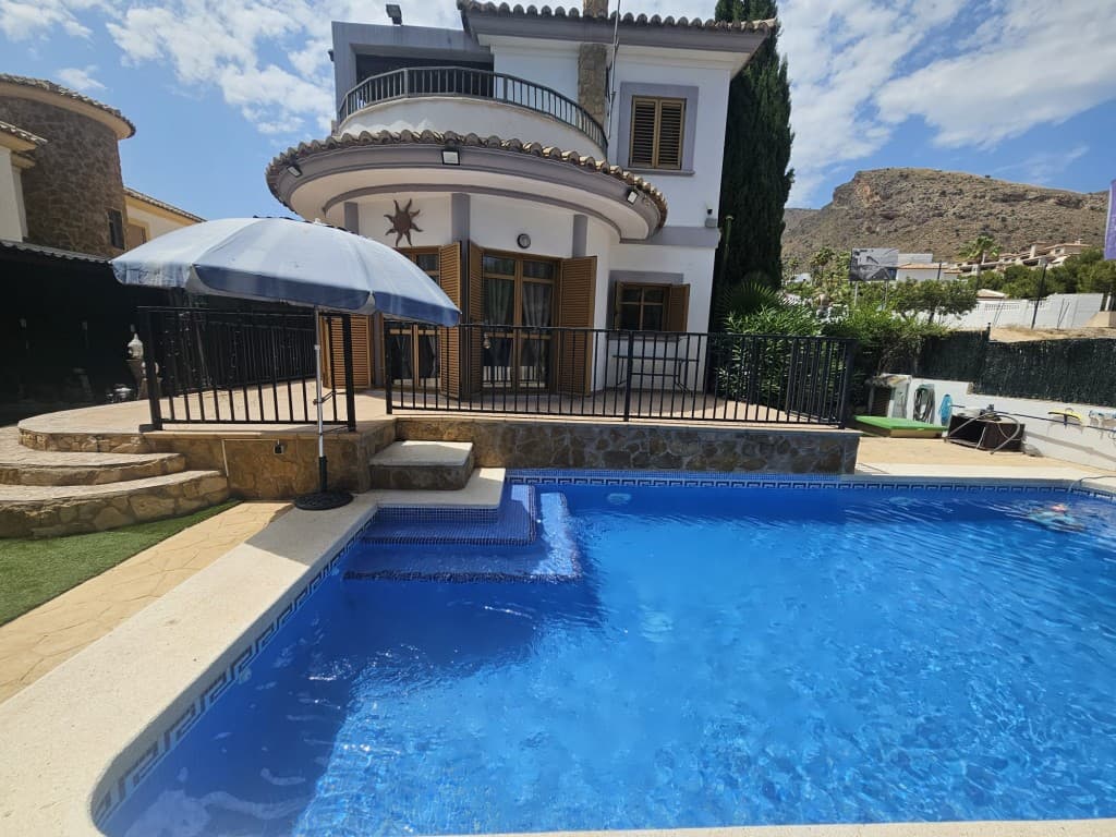 Modern Mediterranean Villa with Sea Views, Private Pool & Garden in Sierra Cortina. This elegant Mediterranean-style villa is located in the highly sought-after Sierra Cortina urbanisation — a secure, exclusive area with 24/7 patrols, surveillance cameras, and no community charges. Set on a 490&8239;m² plot with 180&8239;m² built, the villa is now offered at a reduced price.Built in 2008, the home offers 3 spacious double bedrooms, 3 full bathrooms, an additional guest toilet, an independent fully equipped kitchen, and a bright living room with three large patio doors opening onto the private terrace and 8x4&8239;m pool. A ground floor guest bedroom features its own en-suite and opens to a terrace with a fish pond and waterfall.Upstairs, two more double bedrooms — each with fitted wardrobes and private balconies — offer stunning sea or mountain views. The master bedroom includes a jacuzzi en-suite and two balconies (one Juliet). A separate family shower room is also on this floor.The landscaped garden features mature trees and shrubs with an automated irrigation system, three storage sheds, a powered workshop, and a large shaded summerhouse with electricity for outdoor living and dining. Parking for up to 5 cars (2 inside, 3 outside).Ideally located just minutes from two golf courses, La Marina shopping centre, the beach at La Cala, Benidorm, Altea, and only 35 minutes to Alicante Airport. A rare opportunity for luxury living or investment in Costa Blanca!