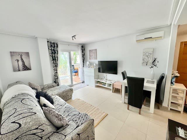 2 bed 2 bath Ground Floor Golf Apartment. We are delighted to bring to market this lovely 2 bed, 2 bath sunny golf facing ground floor apartment.Situated on the Jack Nicklaus designed Hacienda Riquelme golf resort, this property would make the ideal permanent or second home.On entering into a large square hallway, the kitchen is to the right. Fitted with a range of wall and base units, with oven, hob, dishwasher and fridge freezer.A seperate utily room houses the water boiler and washing machine.The 2 double bedrooms have air conditioning the master also has patio doors leading onto the large exterior terrace. The master bedroom also benefits from an ensuite with toilet, vanity and walk-in shower.A seperate family bathroom has a bath, with over head shower, vanity and toilet.There is a large living and dining area again with air conditioning the perfect place to relax.Leading off the living room is the large south facing terrace that benefits from glass curtains and fixed windows, which allows you the opportunity of utilising the room all year round. The glass curtains can be opened up to allow the outside in.Off the terrace is a small enclosed garden which could be lawned or decked depending on what you wish to use the space for.Literally 15 steps from the garden is one of the 19 communal pools on the resort.Underground parking is included and the garage space benefits from a large, built-in private storage shed.Short walk to the on-site restaurant and supermarketMurcia international airport 20 minute driveAlicante airport 55 minute drive