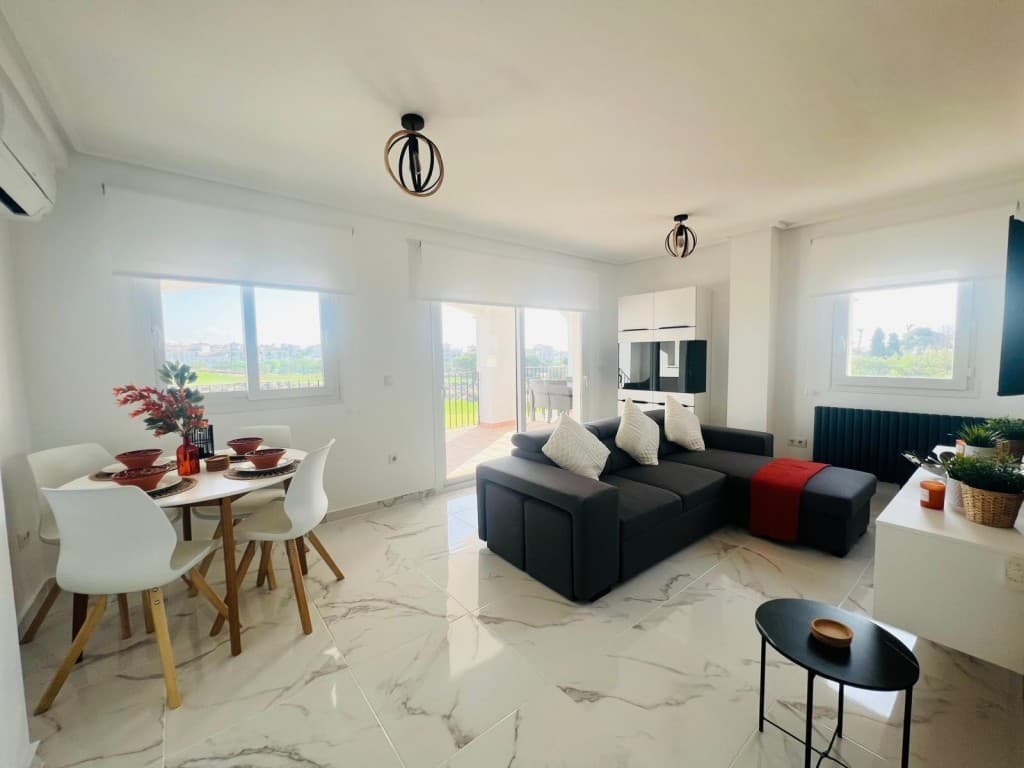 Stunning 2 bed 2 bath upgraded Second Floor Apartment. We are delighted to market this stunning recently re-modelled 2 bed, 2 bath apartment, literally a 2 minute walk to the on-site clubhouse and town centre. Viewing is essential to appreciate how beautiful this apartment is.Situated on the Jack Nicklaus designed gated Hacienda Riquelme golf resort with 24 hour security, this would make an amazing permanent or second home. Ideally situated to explore all the Costa Calida has to offer including the ancient towns of Cartagena and Murcia and the beautiful beaches of the Mar Menor. Just a few minutes drive from the local town of Sucina with plenty of ameneties and bar/restaurants on offer.On entering into this spectacular apartment you can see how much time and effort has been spent by the owners to make this into one of the best apartments on resort with marble floor tiles throughout and white doors which gives it a bright airy feel.The large bespoke kitchen has been designed to a very high standard with quartz worktop, top of the range intergrated appliances, the large window overlooking the putting green and mountains floods the kitchen with natural light.The guest bedroom with large en-suite has new air conditioning, anthracite radiator with 2 single storage beds and designer light and freestanding wardrobe, the fully tiled modern en-suite has a great size walk in shower, vanity unit, led mirror, toilet and anthracite towel radiator.The spacious master bedroom has sliding french doors with views of the lake and golf course. new air conditioning. white sliding fitted wardrobes, anthracite radiator, the beds are zip and link so can be left as two singles or made into a large kingsize. The fully tiled family bathroom is large with a good sized walk in shower, modern vanity unit and basin with large led mirror, wc and anthracite towel radiator.Through the hallway is a black glazed modern door leading into the large living/dining room with new air conditioning, feature wall with wall hung tv and tv unit, anthracite radiator and modern top quality furniture ideal for entertaining and dining, benefits from having two windows and large patio doors with roller blinds which lead out to the large, L-shaped ,fully tiled rear terrace with outdoor dining and lounging furniture. With an EAST orientation it is ideal to enjoy both the summer and winter sun with panoramic views over the putting green, golf course, lake and mountains. perfect for entertaining or sitting and relaxing while taking in the beautiful views.This apartment is been solf fully furnished.Just a moments walk and your at one of the one of the 19 communal on site swimming pools which overlooks the golf course.Complete with underground private car parking space.There is an on-site clubhouse/ bar-restaurant and supermarket only a 2 minute walk away. There are tennis/padel courts, driving range, putting green and outdoor gym. Murcia International airport only a 20 minute drive