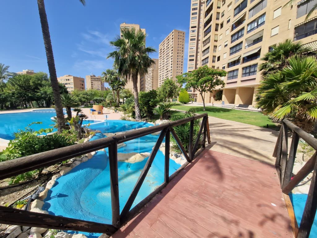 Fabulous 1 Bed Apartment in Benidorm. This absolutely exclusive property stands out for its comfortable design, with a surface area of 80 m², ideal both as a primary or secondary residence, or even as an investment.It has 1 very spacious bedroom with unobstructed sea views, and a living room with its terrace (also with wide views of the sea and the city).The kitchen, fully furnished and equipped, features an induction cooktop, oven, microwave, dishwasher, refrigerator, washing machine, and dryer. It offers mountain views and is complemented by a functional laundry area. The property has ducted air conditioning for both heating and cooling. Hot water is provided through the city gas network. In addition, the built-in wardrobes distributed across various rooms offer optimal storage space.The development offers excellent communal areas designed for the well-being and enjoyment of its residents: extensive landscaped areas with natural grass and trees, a large lagoon-style swimming pool, a tennis court, a sauna, a gym equipped with various machines, and a children's area. The outdoor parking is spacious and equipped with surveillance cameras for added security.Located just a 5-minute walk from the beach, with all services and public transport within reach, this property is ideal for those who value exclusivity, style, and a high standard of living.