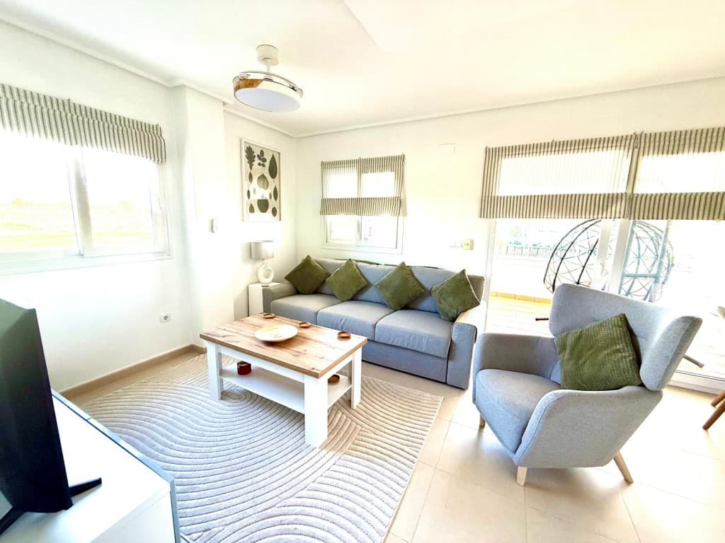 Luxury 2 Bedroom 1 Bathroom golf, pool facing apartment. We are delighted to bring to the market, this beautifully upgraded sought after curved wall designed first floor end apartment with pool, golf and mountain views. Located on the gated community of Hacienda Riquelme golf resort with 24 hour security, 19 communal pools, only a few minutes walk from the on site supermarket and bar/restaurant and only a few minutes drive to the the local town of Sucina with plenty of ameneties and bar/restaurants on offer. Ideally located to explore all the Costa Calida has to offer.On entering this stunning light filled end of block apartment you can see that the owners have taken a great deal of time turning it into a lovely holiday home.The large fully fitted kitchen benefits from a window with roman blind overlooking the communal pool, with upgraded extra storage and shelving, gas boiler and white goods, ceiling fan light and is key-ready and ready to move into.The good sized lounge/diner benefits from an additional window which floods the room with light, with stunning panoramic views, tastefully decorated with modern furniture, air-conditioning,radiator and beautiful contrasting roman blinds on all windows, Ceiling fan light and modern centre light. The double sliding patio doorswith roman blinds lead onto the covered end large terrace which has been turned into an additonal living area with glass curtains with blinds, and stunning breath taking views of the swimming pool, golf course, and mountains, an ideal place to entertain, or sit and have a cafe con leche while taking in the lovely views.The bathroom with window has been fully refurbished to a high standard with walk in shower, rainfall head shower, recess for toiletries and fully tiled with a modern feature wall. Modern double draw vanity unit with sit on basin and tap, mirror, black towel radiator, spotlights, toilet and additional large 2 draw vanity unit with marble top and mirror above, perfect for storage.Both double bright bedrooms are a good size and have sliding door fitted wardrobes , ceiling fan lights, radiator and patio doors with white voiles both opening onto a front tiled balcony with upgraded glass curtains with roman blinds and windows, a fantastic area to sit and read a book while taking in the brilliant views.Private underground parking space with remote control access and lift access.Murcia International airport is only an 18 minutes driveGolden Beaches of the Mar Menor are only a 15 minute drive.This apartment is key ready and viewing is highly recommeded and is been sold mainly furnished.