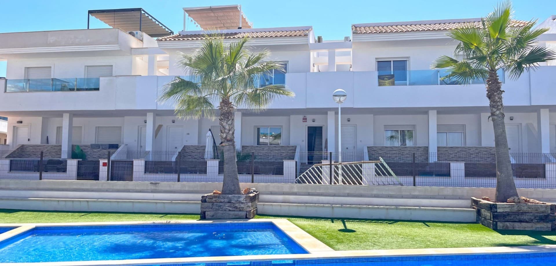 Discover your dream home in this beautifully renovated townhouse located in the sought-after area of Los Balcones, Torrevieja. This modern property boasts 3 spacious bedrooms and 2 stylish bathrooms, perfect for comfortable family living or a holiday retreat.

Step inside to find a bright and airy interior, fully furnished with contemporary decor. The separate modern kitchen comes fully equipped, making meal preparation a pleasure. Enjoy the luxury of multiple outdoor spaces, including a ground floor terrace ideal for al fresco dining, a private balcony overlooking the serene communal pool, and a stunning roof terrace with breathtaking views of the famous pink salt lake.

Additional features include private parking and access to a well-maintained communal pool, creating a perfect setting for relaxation and leisure. Whether you’re soaking up the sun, entertaining guests, or enjoying the tranquil views, this townhouse offers a lifestyle of comfort and convenience. Don't miss the chance to make this exceptional property your own!