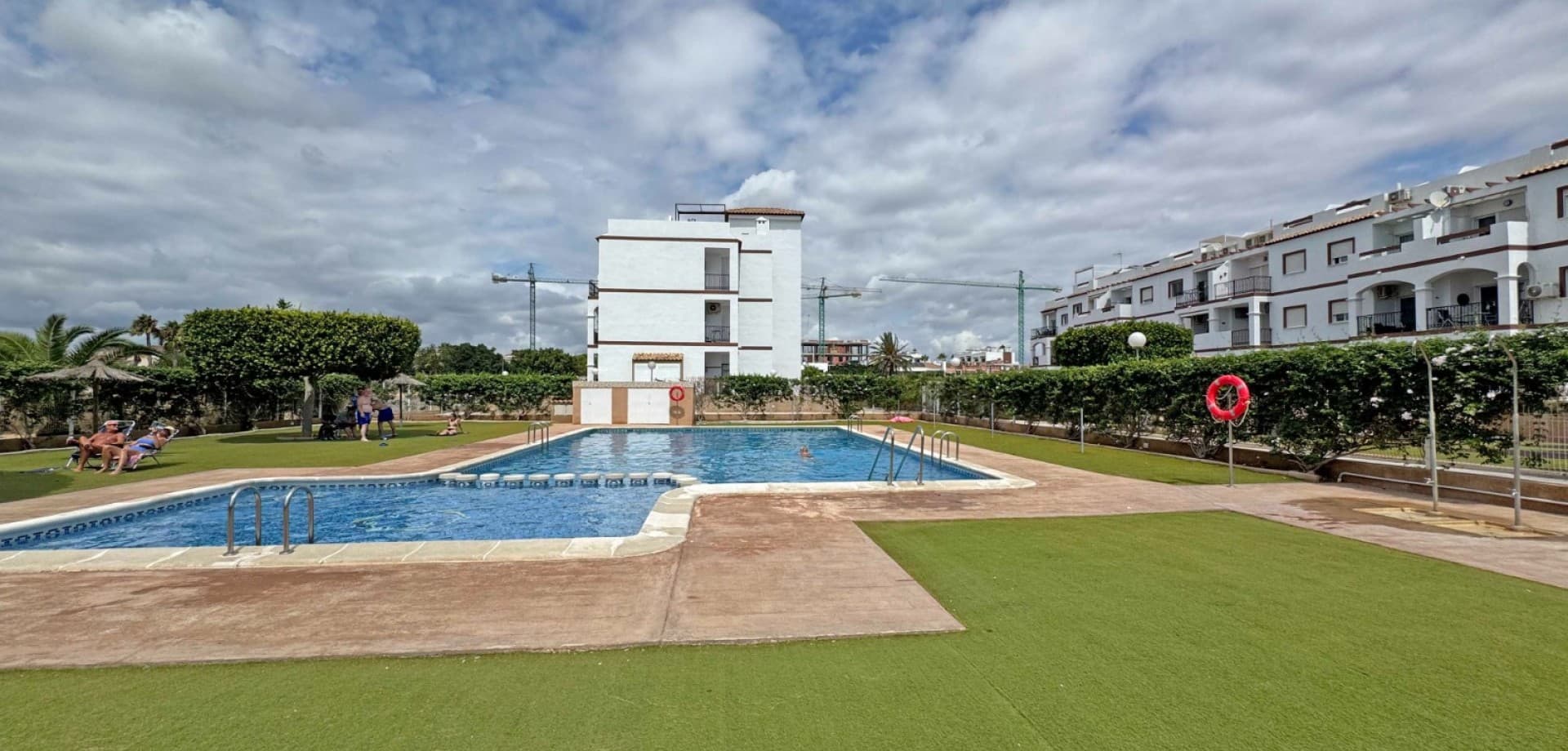 This well-maintained apartment offers an exceptional opportunity to enjoy coastal living just 900 meters from the Mediterranean in the popular area of Punta Prima, Orihuela Costa. Located on the second floor of a residential complex built in 2008, the property combines comfort, convenience, and investment potential.

With a total built area of 97 m², the apartment features a bright and functional layout comprising:





2 double bedrooms with built-in wardrobes





2 full bathrooms, including one en-suite





Open-plan living and dining area with natural light and direct access to a private balcony





Modern, fully equipped kitchen





Private rooftop solarium with panoramic sea views and a sun tent—ideal for sunbathing, dining, or relaxing outdoors





Additional features include air conditioning, partly furnished interiors, and a private parking space within the community. Residents benefit from access to a communal swimming pool and a peaceful setting within a gated complex.

The apartment is in excellent condition and ready to move into, with easy access for people with reduced mobility (no elevator, but exterior access is adapted).

Situated in a quiet yet central area, all essential amenities are within walking distance—including supermarkets, restaurants, pharmacies, and bus connections. The beach and the Zenia Boulevard shopping centre are also just minutes away.

This property is ideal as a permanent residence, a holiday home, or a high-yield rental investment, offering a low-maintenance lifestyle with sea views in one of the most desirable areas of the Costa Blanca.