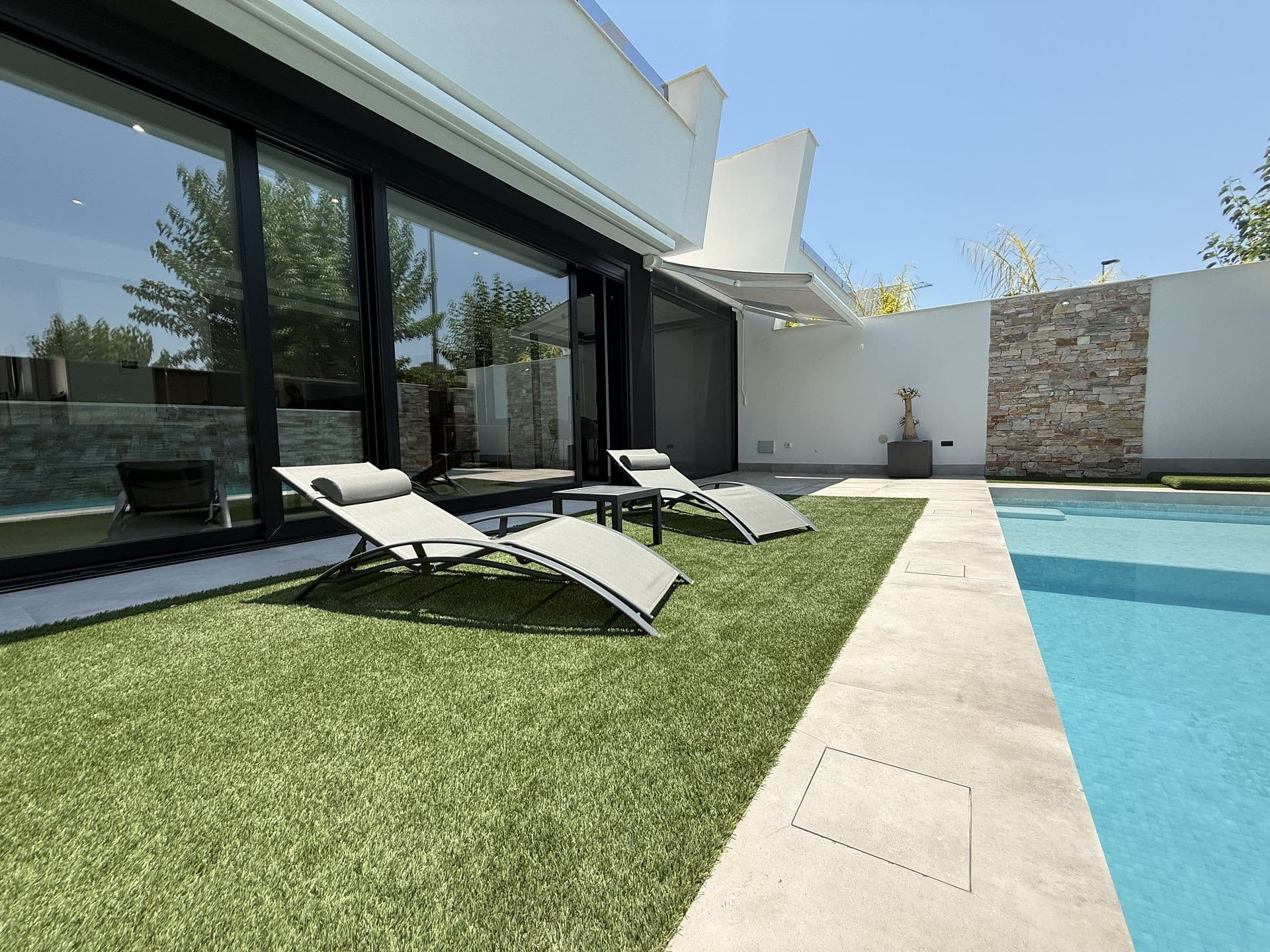 Family Villa in San Javier Murcia!. Enjoy the tradition, modernity, and innovation, present and future, all under the same roof. We are finding harmony between the environment and the quality of your home. Enjoy this family home in a traditional Spanish town, with all amenities within walking distance. Imagine, the Mediterranean Sea with sandy beaches is just 600 meters from your home! Your gorgeous Spanish family villa, designed to provide you and your family with elegance, practicality and comfort. Enjoy the spacious terraces offer the perfect setting for relaxing and taking in the fresh air. Appreciate the beauty of nature and admire the breathtaking scenery surrounding the property. The private pool invites you to relax and refresh on hot days. The area around the villa offers countless entertainment and leisure options. You can take advantage of the nearby golf clubs, participate in sporting activities, attend international schools, explore shopping centres and pamper yourself with spa treatments. In addition, two International Airports are close to your home.Take this opportunity now to enjoy living in this incredible place! Contact us for more information, and enjoy Spain as your new home!Additional Features1. Underfloor heating throughout the entire house2. Central air conditioning system, individually controlled in each room, controlled by app3. External security cameras with WiFi access4. Alarm system installed by ADT, with direct connection to the police5. Mosquito screens on all windows in bedrooms, living room, and bathrooms, including two large automatic ones in the living room and an additional pleated screen in the bioclimatic pergola6. Bioclimatic pergola with adjustable roof, RGB LED lighting, and colour-changing system7. Water softening system8. Large automatic awning in the living room9. Manual awning in the bioclimatic pergola10. High-end household appliances: Siemens oven andmicrowave, AEG dishwasher, Bosch fridge and freezer, Bosch extractor hood and induction hob11. Stone kitchen countertop with a wood-effect finish12. Samsung washer and dryer13. The house features four bedrooms and a living room14. Furniture includes a leather corner sofa with chaise longue and extendable porcelain dining table with wooden legs, four leather chairs, wooden TV cabinet and 85” Samsung 4K High End TV plus two open wooden bookshelves from the Spanish brand Cerda15. A fully equipped outdoor kitchen in the solarium, including a sink, fridge, and induction hob. Enjoy the solarium and terraces, which are fully furnished with Dutch furniture, featuring a table, six chairs, and two corner sofas.16. Solar panels with two power walls17. High-end boiler, also remotely controlled via WiFi18. Enclosed storage area in the garden for tools and maintenance equipment19. Remote-controlled electric blinds via Smart Home system app20. Built-in wardrobes in all rooms21. Robotic pool cleaner22. Automatic irrigation system for garden plants and many more