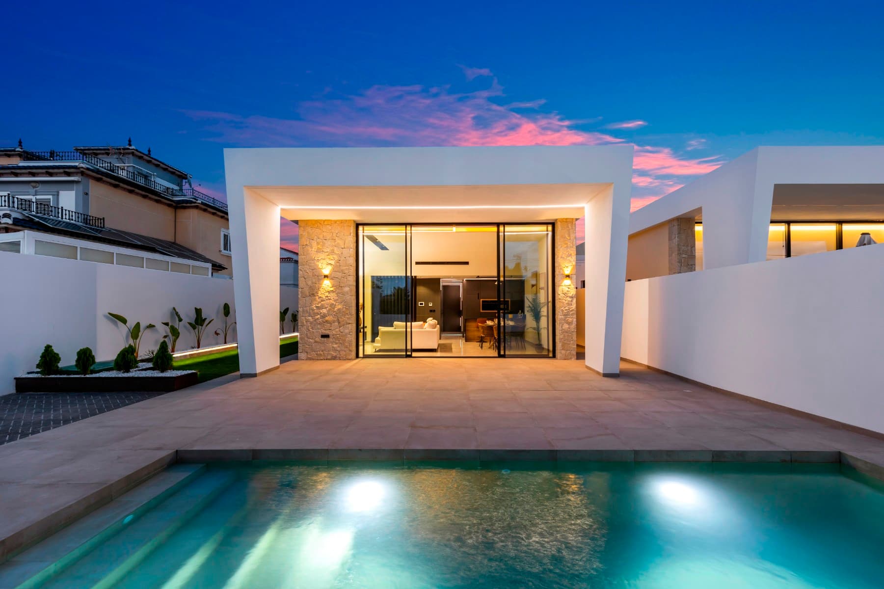 Discover the life you've always dreamed of in this exclusive new construction project that redefines the concept of functional luxury in the prestigious Torreta Florida Urbanization in Torrevieja. These villas have been designed with quality of life in mind, combining an unbeatable location with cutting-edge architectural design and a profound respect for natural light.A Design that Connects with Nature and LightEach villa is a haven of serenity. With a construction of 145 m² on plots of 400 m², these homes offer a modern, open-concept layout. The renders show a bright and spacious interior, where the living room, dining room, and kitchen merge into a single fluid space. The minimalist aesthetic, with straight lines and a neutral color palette, creates an atmosphere of calm and sophistication. The porcelain tile floors and large windows not only provide elegance but also maximize the entry of light, turning every corner into a vibrant space.The exterior of the villa is a true private oasis. Imagine enjoying a spacious garden with lawn, palm trees, and a refreshing private pool (optional) where you can relax and sunbathe. The 60 m² rooftop solarium offers an intimate space with clear views, ideal for moments of peace or for socializing under the Mediterranean sky.Quality and Personalization in Every DetailIn these homes, quality is a priority. The properties include high-end standard equipment, such as thermal and acoustic insulation, Technal windows with thermal break and electric shutters, an armored door, and radiant floor heating in the bathrooms.Additionally, the project offers a range of customization options to make your home unique. From the integration of BOSCH appliances and smart lighting to the installation of solar panels or a saltwater pool. The detailed plans also show the possibility of a 60 m² basement with various configurations, which can be transformed into a gym, a home theater, or a workspace.A Strategic Location for a Full LifeLocated just 5 minutes from the center of Torrevieja, these exclusive villas offer the tranquility of a residential urbanization without giving up the convenience of having everything within reach. The area is surrounded by services, supermarkets, health centers, and parks. Furthermore, it is close to the most famous beaches in the region and at an ideal distance from prestigious golf courses.These villas are more than a house; they are an investment in a lifestyle of luxury and comfort. Contact us for more information on prices and the availability of the SUNRISE plots.