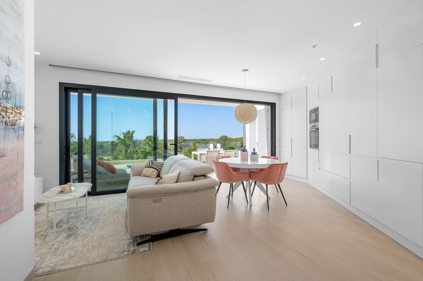 Discover this fantastic apartment located on the edge of the renowned, award-winning Las Colinas Golf Resort. Move in immediately: fully furnished and equipped with high-quality Bosch appliances, kitchenware, stylish décor, and even bed linen. The home features a sleek, modern design with an open-plan kitchen that can be closed off to disappear seamlessly, a unique feature you have to see in person. The bright living room is bathed in natural light thanks to floor-to-ceiling sliding doors, creating a perfect connection between indoor and outdoor living. Step onto the 20 m² south-facing terrace and enjoy endless sunshine and breathtaking views over the surrounding natural park. With nothing ever to be built in front, these panoramic views are yours to keep forever. The apartment offers two spacious double bedrooms, including a master suite with ensuite bathroom and built-in wardrobes. Imagine waking up to sweeping views of the resort right from your bed. All windows are fitted with electric blinds and curtains, so you can control sunlight while still enjoying the scenery. Both bathrooms are in pristine condition, fitted with underfloor heating for extra comfort during the cooler Spanish winter days, and fully equipped with modern fixtures. Additional highlights include: A large private underground parking space Two generous storage units Direct access to your front door via elevator Community poolAccess to the WOW Beach by Las Colinas beach club in Dehesa CampoamorLife at Las Colinas Golf Resort means exclusive access to first-class amenities: a luxurious clubhouse with panoramic views, a wellness centre, tennis courts, and three restaurants offering both international and local cuisine. Whether you’re looking for a permanent residence, a smart investment, or a private retreat for sunny getaways, this apartment offers the perfect blend of luxury, comfort, and exclusivity in one of Spain’s most sought-after resorts.