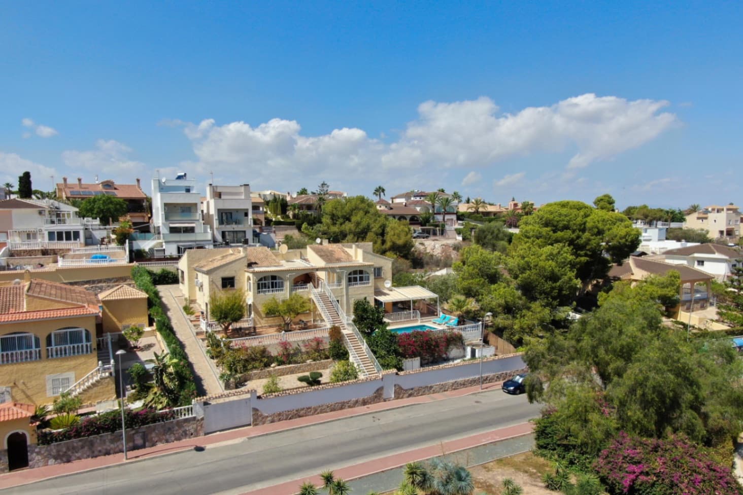 This expansive property offers the perfect retreat for both relaxation and independence, featuring seven beautifully refurbished apartments designed for the modern traveler. Each apartment is equipped with its own fully functional kitchen, a cozy living area, and a private bathroom, ensuring guests can enjoy the comfort and autonomy of their own space while having access to the premium amenities of the villa.Step outside and discover a stunning pool area, offering the perfect setting for a refreshing swim or a peaceful sunbathe. The villa is also equipped with a smart entry system, allowing guests to conveniently grab their keys and enter whenever they wish, ensuring an effortless check-in experience.For your convenience, there are two spacious parking areas where you can drive up and easily unload your belongings. If work brings you here, the upstairs office provides a quiet, serene space to handle business while enjoying the tranquility of your surroundings.Located just a minute’s walk from the villa, you'll find a massive park, a dog park for your furry friends, and a tennis court—perfect for enjoying outdoor activities in a lush, green environment. Whether you're taking a leisurely stroll, playing a friendly game of tennis, or letting your dog run free, these outdoor spaces add a whole new dimension to your stay.This villa is the perfect blend of independence, luxury, and nature, offering an unforgettable experience for tourists, families, or business travelers alike. Escape to a place where every need is met and relaxation is just a step away.