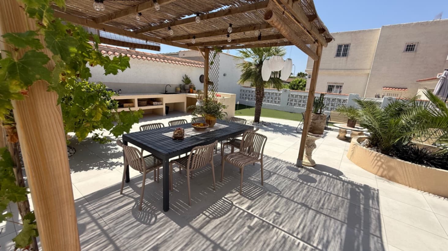 Introducing this beautifully presented three-bedroom, two-bathroom detached villa, ideally located in the highly sought-after neighborhood of El Chaparral / San Luis - Costa Blanca South. Set on a generous plot of approximately 800 m², this property offers a rare blend of privacy, space, and refined style. Surrounded by privacy walls and accessed via a secure entrance, the villa boasts a tranquil and inviting ambiance from the moment you arrive.The home has been thoughtfully updated to a high standard, blending clean Nordic design with the warmth of traditional Spanish elements. The result is a harmonious and welcoming interior that feels both contemporary and timeless. The spacious, glass-enclosed veranda overlooks the stunning pool area and manicured, low-maintenance gardens, creating a seamless indoor-outdoor living experience that can be enjoyed year-round. The propeties gardens have a coveted southwest-facing orientation, bathed in natural sunlight throughout the day—perfect for sunseekers and al fresco entertaining. Various chill out zones, salt water pool, dining areas, solarium with view to the salt lake and outdoor kitchen really complete this outdoor oasis. The gardens are full of fruiting trees inc: orange, blood orange, mandarin, lemon, mango and olive.Additional features include off-road parking, a dedicated storage area, an outdoor full bathroom for poolside convenience, and beautifully tiled exteriors designed for easy upkeep. Every corner of this home has been carefully considered to maximize comfort, style, and functionality.Ideally situated just moments from local amenities, with easy access to Torrevieja, the Habaneras shopping centre, and the beaches of the Costa Blanca, this villa offers both convenience and a serene lifestyle setting. Whether you’re looking for a permanent residence, a holiday retreat, or a smart investment, this is a property not to be missed.