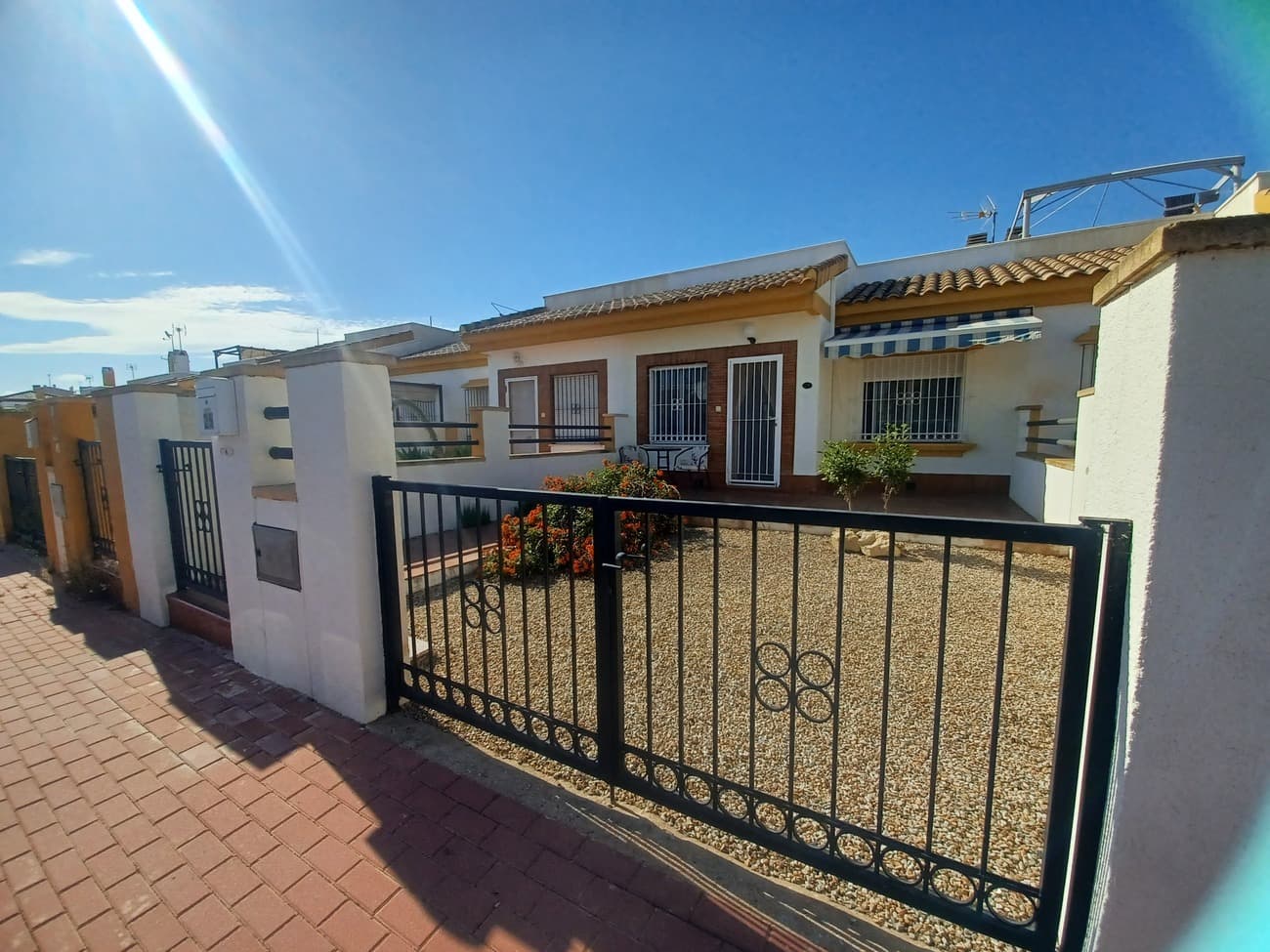 This very nice bungalow villa in Sucina has a lot to offer, it is private, with plenty of outside space with front garden, inner patio, large roof terrace and nice views.  Set in a quiet residential street the house has a surrounding wall to create privacy, a pedestrian gate and a drive gate.  The garden is South facing orientation with sunshine all day long; with plenty of space for garden terrace.  There is a full roof terrace the size of the house with great views and a nice breeze.  The villa enters into a living, dining room with open plan kitchen; furnished with sofa, 2 armchairs, TV unit, dining table and chairs and with open plan kitchen including fitted kitchen, oven, extractor, ceramic hob and  fridge freezer.  The kitchen leads to an indoor patio area with mosaic tiles, it can be used for shaded outdoor dining area or for storage;  there is a stairwell leading up to the roof terrace.  There are two double bedrooms, one to the front of the house and one to the rear of the house separated by a very large bathroom.  The main bedroom at the front of the house is furnished with a double bed, bedside cabinets and fitted wardrobes and comes with airconditioning.  The second bedroom is also a double with double bed and fitted wardrobes with airconditioning.  The bathroom is very spacious including a wc,  large shower, vanity unit, wc and bidet, fully tiled to a high standard.  This well maintained house is just a short walk to the centre of the traditional Spanish village of Sucina will all amenities and just 15 minutes drive to the coast and 20 minutes drive to the nearest airport.  This house is ideal for a holiday home or for permanent living and is highly recommended for viewing.