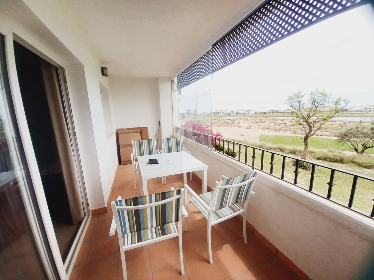 Situated close to the club house in Calle Atlantico, this first floor apartment on Hacienda Golf Resort offers spacious living, spectacular views and South facing terrace to enjoy sunshine all year round with glass curtains to open and close.  The apartment enters into a spacious living room with curved wall feature, currently furnished with dining room table and chairs, sofa, storage units and TV.  The kitchen is to the right and it is a very spacious kitchen with window views to the golf course, fully fitted kitchen including vitro ceramic hob, extractor fan, fridge freezer, dishwasher, washing machine and wooden table and stools.  The living room leads to the terrace space, ideal for sunbathing and alfresco dining, this space has a very privileged views of the golf course.  The living room leads to a hallway which leads to a large bathroom with bath, vanity unit with wash hand basin, wc and bidet.  There are 2 double bedrooms to the rear of the apartment, both leading onto a second terrace; both bedrooms come with ajoining twin beds as a double beds.  The apartment comes fully furnished with airconditioning, gas central heating and underground parking space in a resort with extensive gardens, 24 hour security, sports facilities and just a short drive to the village of Sucina, 20 minutes drive to the coast and 20 minutes drive to the airport.  An ideal apartment for holidays or permanent living.