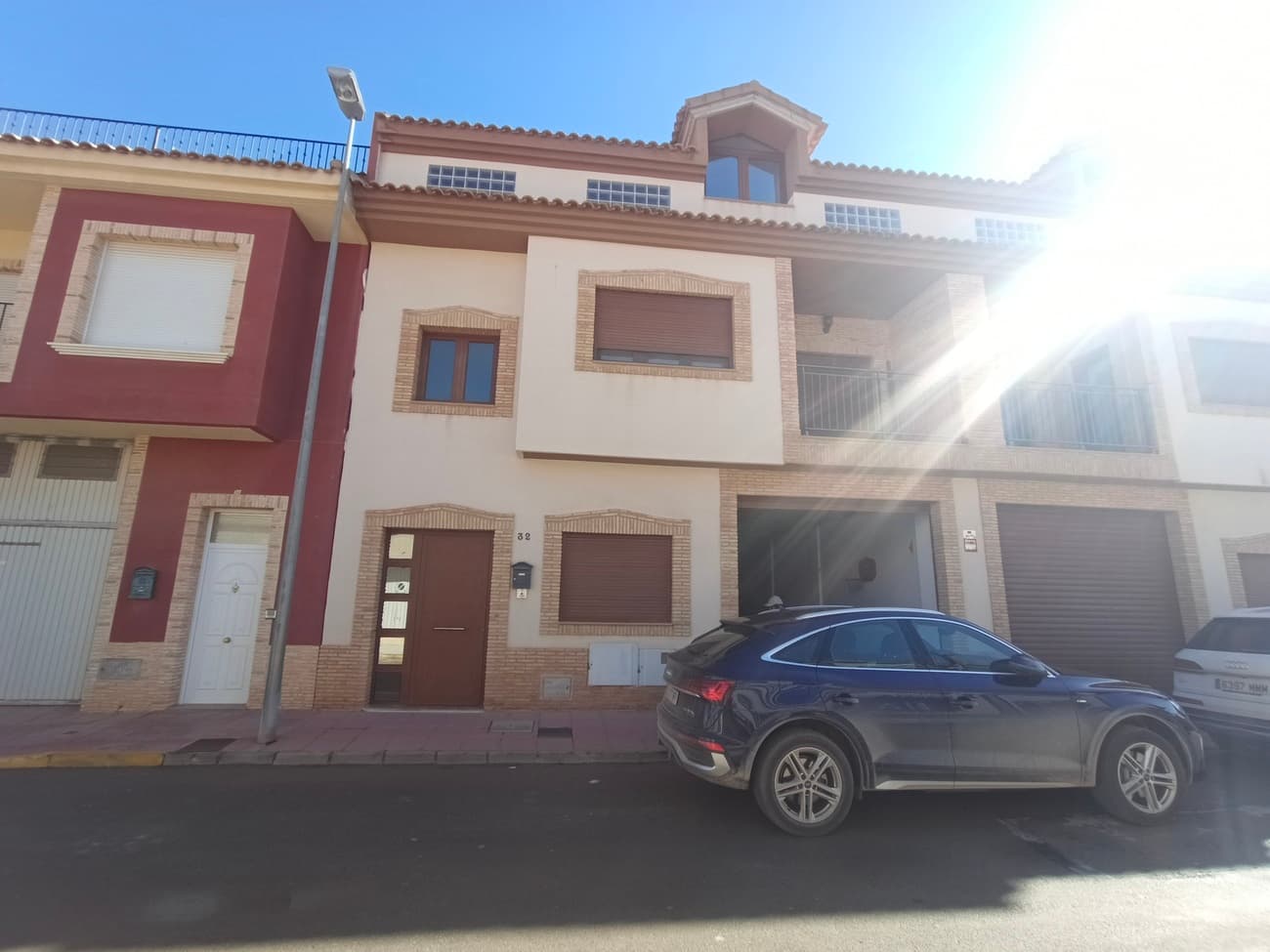This exceptionally spacious townhouse in Roldán offers modern living finished to a very high standard, with extensive accommodation and enormous versatility. With over 300 m² of built living space, the property is arranged over three levels and includes a very large garage, a first-floor main living area, and a second upper living level, all connected by an elegant stairwell and a pre-installed lift shaft (a lift can be added if desired).The property is located on a quiet residential street in the traditional Spanish village of Roldán, offering peace, privacy, and easy access to local amenities.The house is entered through the front door into an impressive stairwell with marble flooring and a marble staircase leading to the upper floors. To the right, there is a substantial garage measuring approximately 125 m², providing ample space for multiple vehicles, bicycles, storage, or potential conversion, subject to requirements.The stairwell leads to the first floor, which forms the main living area of the home. Here you will find a large, fully fitted kitchen with extensive pantry storage, Silestone worktops, ceramic hob, oven, extractor fan, fridge-freezer, washing machine, dishwasher, and dining table with chairs. The kitchen opens directly onto a south-facing terrace, perfect for enjoying sunshine throughout the day.Also on this level is a spacious and comfortable living room, furnished with leather sofas, parquet flooring, and generous storage units. This is a relaxing and welcoming space, ideal for family living, and it leads onto a further terrace where you can enjoy fresh air and outdoor relaxation.The first floor also offers two double bedrooms. The main bedroom features an en-suite bathroom with bathtub, vanity unit, WC, and window, as well as a walk-in wardrobe providing excellent storage space. The second bedroom is also a double and comes complete with fitted wardrobes, a double bed, and bedside cabinets.A further stairwell leads to the upper level of the property. On this floor, there is a striking loft-style space with very high ceilings, feature windows, and doors leading onto another south-facing terrace. There is also an additional enclosed double bedroom with fitted wardrobes, drawer unit, and high-quality parquet flooring.The open loft area is currently used as a study but could easily be converted into a fourth bedroom, or even a fifth if required. This flexible space would be ideal as a studio, playroom, home office, or independent living area, especially as this level offers the potential for separate access and benefits from the existing lift shaft.Completing this floor is a large bathroom fitted with a walk-in shower, vanity unit, and WC, finished in light neutral tones and filled with natural light.This unique property has been built to specification and offers outstanding flexibility. It is ideal for a large family, multi-generational living, home-working professionals, or buyers seeking a property with space for a business, studio, or office.With its generous proportions, high-quality finishes, and huge potential, this townhouse is a rare opportunity to buy such a spacious property close to all amenities in the town of Roldan, just 20 minutes to the coast, 20 minutes to the city and 25 minutes to Murcia city.
