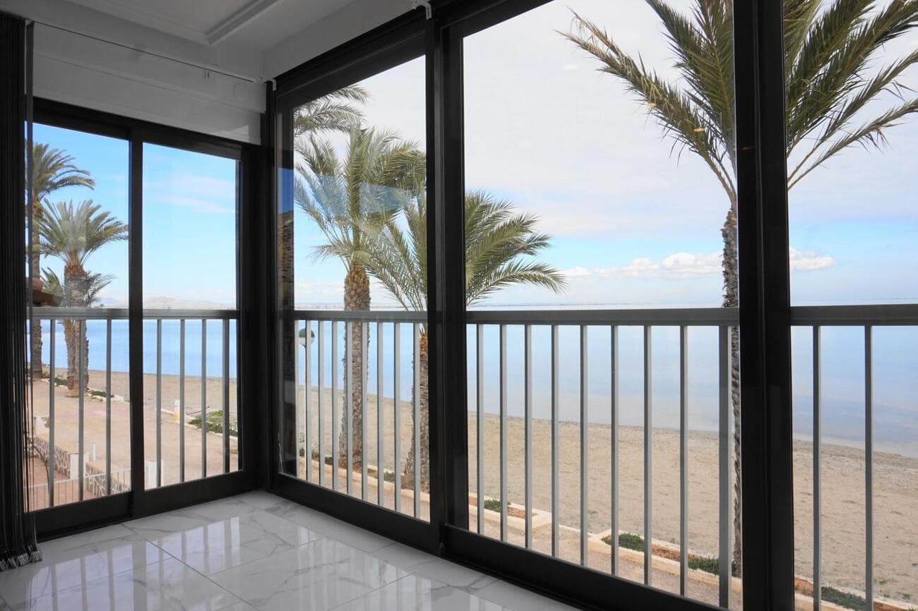 If you are looking for tranquility close to the beach, this fantastic beachside apartment has your name on it. Refurbished to a very good standard, the accommodation comprises of 2 double bedrooms with fitted wardrobes. Fully fitted kitchen with electrical appliances. Two modern bathrooms with walk-in shower. Spacious light filled living room with incredible panoramic views across the beach to the calm waters of the Mar Menor. The large windows slide back so that the living area merges seamlessly with the balcony overlooking the beach just 14 feet from the front of the building. The apartment is on the top floor of this two storey building and shares a large roof top solarium with the five other apartments in the same block.The apartment has a built area of over 90 square metres.The building was built in the 1970s There are three apartments on the upper floor and two on the ground floor. The renovation includes new ceramic tiled floors and new ceilings. New windows and doors, new filtered water system throughout, new water heater. New Airconditioners with remote control. New lighting throughout and new trip switch fusebox. and smoke alarm.Los Urrutias is a small beach side community with a dozen cafes and restaurants which remain open year round. The nearest main town is Los Alcazares which is only 12 minutes drive away, also the historic Roman city of Cartagena is just 25 minutes away by car with excellent shopping centres and great night life. The new Murcia International Airport is 30 minutes. The fabulous La Manga golf courses are just 15 minute drive and Los Urrutias has tennis courts, horse riding, and all kinds of watersports on your doorstep!This beachside apartment represents a fantastic investment opportunity and will achieve a strong rental incomeContact our team today for soonest viewing.