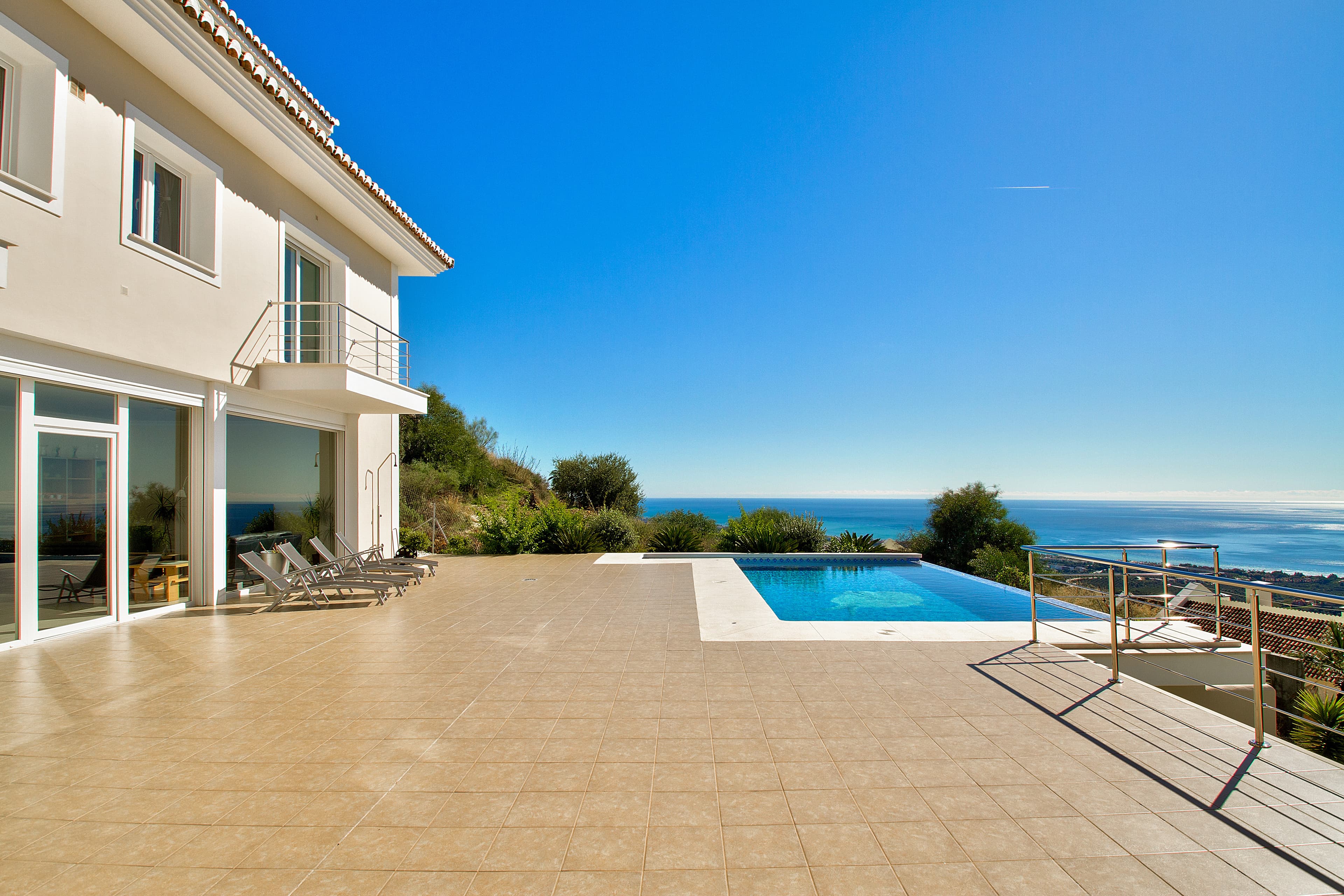 Beautiful villa from 2012 build to a very high standard.From every room in the house you can enjoy a fantastic panoramic sea view and view over the whole coast. From the entrance of the house you have a large closed garage with space for 2-3 cars inside. To enter the rest of the house you can either use the stairs or the lift, which gives access to all levels of the house.On the main level you will find one bedroom, livingroom, bathroom and kitchen - and from the livingroom and kitchen you can access the big spacious terrace with the pool and a lot of sun all day. Alle rooms are installed with underfloor heating, double glazing windows and insulation. Downstairs you will also find a indoor pool, jacuzzi and sauna - both pools are heated and with a function to be able to work out with residence in the water. The garden is made up and has its own water irrigation system installed, so the garden doesn't need a lot of work and is easy maintained