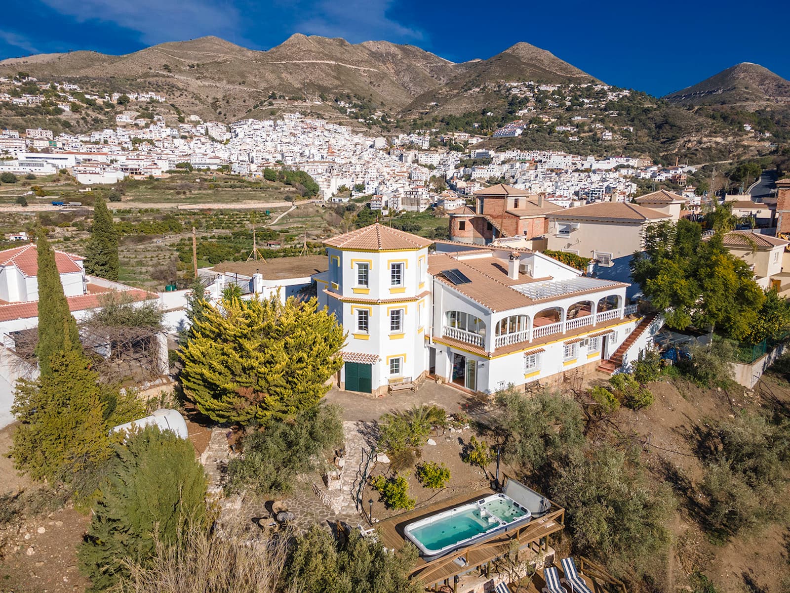 BEAUTIFUL AND WELCOMING VILLA WITHIN WALKING DISTANCE TO COMPETA.This architect designed property of 350 m2 with 4 rooms, 2 bathrooms and an independent guest section with 1 bedroom, bathroom, kitchen and living room, is located in the lovely and beautiful Competa, and offers a fantastic 340 degree view to both Competa, Canilla de Albaida, Coumbela, the Maroma mountain and the Mediterranean Sea, this view can be enjoyed from all the angels of the house. The villa is beautiful and offers many cozy terraces. The beautiful swim/spa pool area also invites to many wonderful hours throughout the year. From the lovely garden you can catch the sun from early morning to the beautiful sunsets and you certainly do not feel that you are only 5 min walking distance from the town. The property appears incredibly beautiful, well maintained and architecturally correct and offers all modern comforts such as; double glazing, and mosquito screen, shutters, central heating on gas everywhere, new large wood stove, air con, solar panels for both water and electricity, private gate system, parking, carport, fenced garden, water system, water tank for rainwater, separate water tank and heated swim/spa pool with cover.The large, beautiful entrance area welcomes you into the hall and if you enter the first large bedroom, there is plenty of space and built-in wardrobes. Next to the bedroom there is a large and new nice bathroom with an extra-large shower, the next bedroom is the spacious master suite, which has a large En-suite bathroom with both spa and shower cabin as well as separate dressing room. From this room there is the most beautiful view of the sea. From the hall you walk directly into the fantastic beautiful and large open plan living/dining room and kitchen. The heart of the property is the large kitchen, from which there is light from all sides and a magnificent view of the garden and to the Spanish patio, here you really feel that you are in Spain with the beautiful Spanish tiles that surround this cozy patio. The sunroom, which is located En-suite to the living room, is used extensively by the whole family and here can enjoy sunsets all year round. From the sunroom you go directly out to the large beautiful, covered terrace, where you can really enjoy the beautiful view and nature, here is plenty of space for both lounge furniture and sun chairs. There is also a cozy BBQ area in connection with this terrace as well as a smaller cozy courtyard. From here, a staircase leads down to the lower part with garden, guest apartment and pool area.The living room, dining room and kitchen invite you to socialize with family and friends. The 3 living rooms En-suite give the feeling of light and air from all sides. The floor plan is incredibly well decorated. From the dining room a staircase leads up to the third bedroom, this room can also be used as an office or studio. There is a lovely roof terrace which has fantastic views towards Competa and Canillas de Albaida as well as the mountains – in the evening this spot is absolutely fabulous with all the lights from the houses that can be seen from Competa.In connection with the dining room, another staircase leads down to the lower floor, where there is a storage room and the fourth bedroom with sliding doors facing the pool area. In connection with this bedroom/studio there is another smaller room, which could become an extra bathroom for this bedroom. The separate guest apartment can be reached both from inside the house as from the outside, the guest apartment offers an open plan living room/kitchen, nice large bathroom, and cozy bedroom, here can easily be 4 people - perfect for family or friends - or as a rental.The plot is 2500m2 and is fully fenced, the swim/spa pool area is laid out on two beautiful wooden terraces, which blend beautifully into nature, this swim/spa pool can be heated and used all year. There is another large cover for the pool, so the heat does not disappear at night. Close to the pool area, the large old olive tree has been preserved and this beautiful terrace, which is built around the tree in natural stone, is unique and has a certain tranquillity about it. The garden is in every way inviting with old lemon, orange, tangerine, olive, and almond trees, small terrasses where both sun and shade can be selected and deselected throughout the day. And then here is an exquisite peace and quiet. The experience and the feeling of light, air and privacy is unmistakable, a beautiful villa - and even in the heart of yours & my Competa..