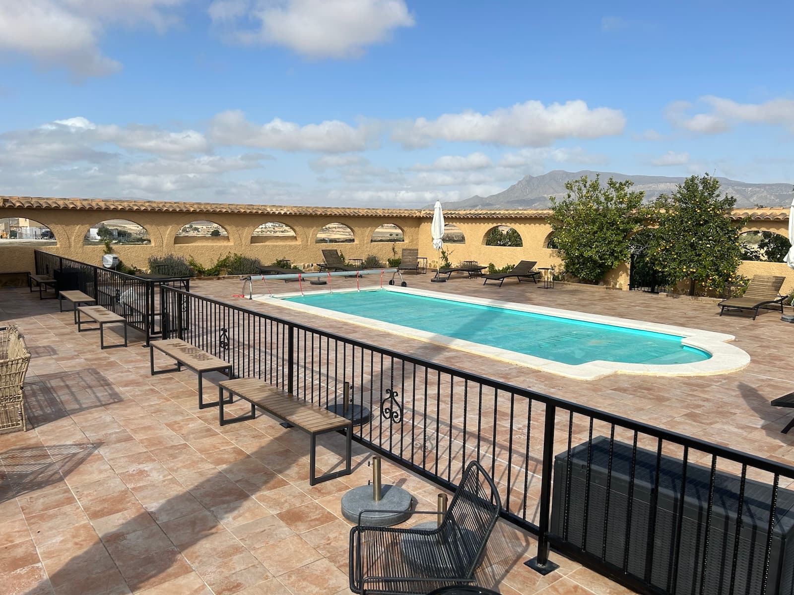 Large Hacienda for Sale – Ideal for Rental with Plenty of Development PotentialThis impressive hacienda offers a unique combination of luxury, space, and opportunities – perfect for both private stays and as an exclusive rental property. It also presents an excellent opportunity for use as a Bed and Breakfast or for corporate retreats. With 10 spacious rooms and suites, as well as numerous amenities, the property is designed to meet the needs of large families, groups of friends, or guests seeking a luxurious and private retreat.Most rooms are equipped with a large, modern en-suite bathroom and a tea kitchen, while the suites, Rooms 9 and 10, have private access via the first-floor terrace, providing extra privacy and exclusivity. This setup makes the property ideal for rental, allowing for a variety of stay options and privacy levels for guests.The hacienda’s outdoor spaces are spacious and inviting. The ground-floor terrace leads out to the swimming pool, and the property also features a large, fenced garden that includes a small football field.The property is situated in an open and scenic terrain surrounded by mountains, making it a perfect choice for active guests who enjoy outdoor activities. The area is ideal for cyclists and runners seeking a natural experience, with the mountain landscape offering both challenge and beauty.Inside, the property is equipped with a large kitchen on the ground floor with all necessary amenities, as well as a smaller kitchen on the first floor. A spacious dining room with a long table comfortably accommodates all guests, and a cozy lounge with sofas and a television invites relaxation.The hacienda is also equipped with solar panels, which reduce energy costs and make the property more sustainable.With a location just 50 km from major cities like Elche and Murcia, as well as smaller towns nearby, and only 64 km from the nearest airport, this hacienda is ideally located for rental guests eager to explore the area.Contact us today for more information on this luxurious property with ample potential.