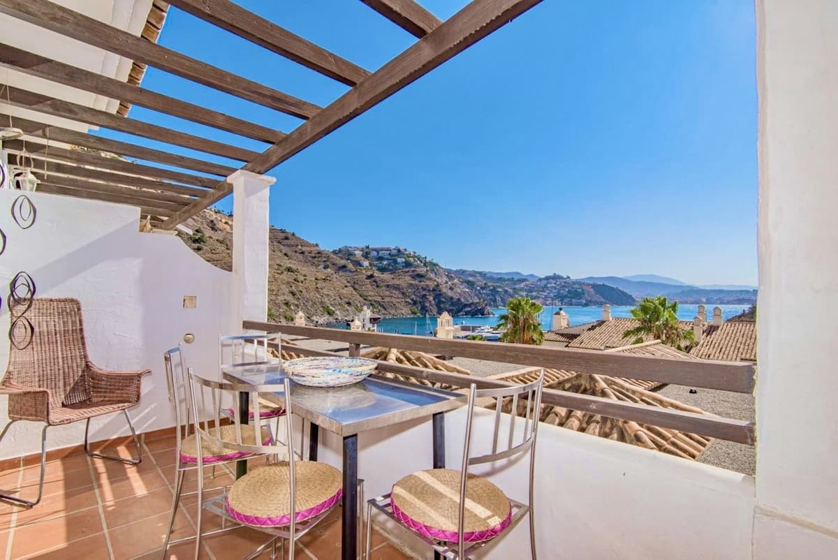 This charming semi-detached house in the prestigious Marina del Este development offers you a unique opportunity to live just a few steps from the sea. With a privileged location, you will be in the marina and surrounded by restaurants and shops, as well as enjoying the proximity to the beach.The house, built in 2003, stands out for its two terraces with impressive sea views and a large 24-square-meter patio with covered areas, perfect for enjoying outdoor gatherings. On the ground floor, you will find a garage more than seven meters deep and a six-square-meter loft/storage room, ideal for extra storage.The first floor welcomes you with a bright east-facing living room that opens onto a terrace, and a kitchen with direct access to it. In addition, it has a bedroom, a bathroom and a practical laundry area. On the second floor, two bedrooms open onto another east-facing terrace, accompanied by a full bathroom.With 160 m² of built space, the house is ready to move into.It has a parking space and is in good condition, offering all the comforts necessary to enjoy the coastal lifestyle.Don't wait any longer to make this house your home by the sea.Come and visit it and fall in love with its views and surroundings