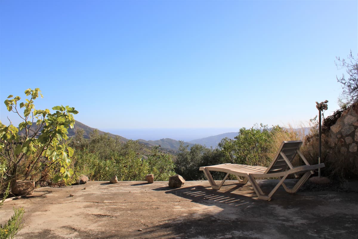 Spacious Property with Stunning Mountain and Sea Views.OverviewDiscover your own paradise with this exceptional property featuring a large plot, private water supply, and a charming house with breathtaking views of the mountains and sea. * * Located between Jete and Itrabo, this property offers endless potential for expansion and customization, including the possibility to add a private pool, expanding the living area up to 150 sqm.Key FeaturesExpansive Plot: The officially registered 7,282 sqm plot is adorned with numerous olive trees and a few almond trees, providing a lush, green landscape.Private Water Supply: Enjoy the benefits of your own legal water well, eliminating water bills and supporting the irrigation of your olive and almond trees.Scenic Views: Marvel at the stunning panoramic views of the mountains and distant sea, offering a serene and picturesque setting.House DetailsSolid Construction: Built with durable Y-tong blocks and high-quality windows that maintain interior temperature, ensuring comfort in all seasons.Living Space: The house includes a kitchen, bathroom with shower, and a combined bedroom and living room, ideal for flexible living arrangements.Interior Features: The kitchen and bathroom feature tiled floors, while the living room boasts wooden flooring. The covered terrace and house together span 50 sqm.Expansion Potential: The house can be extended up to 150 sqm, including the addition of a private pool, making it a perfect year-round residence.Well-Planned Land: The surrounding land is open and well-organized, providing numerous opportunities for further development.Additional AmenitiesWater Pump Room: A 25 sqm water pump room carved into the hillside, doubling as excellent storage space.Outdoor Terrace: A spacious terrace outside the pump room with magnificent views, ideal for evening barbecues and outdoor entertainment.Solar Power: The property is ideal for solar panel installation, and a small unit is already in place, along with a septic tank for wastewater management.Location HighlightsConvenient Access: Located less than a 10-minute drive from the nearest supermarket in Itrabo, with mostly paved or cemented roads leading to the property.Peaceful Environment: Enjoy a tranquil and peaceful setting with nearby neighbors, providing a perfect balance of privacy and community.Proximity to Amenities: Almuñécar's city center, offering a wide range of amenities, is just a 30-minute drive away. Malaga Airport is an hour’s drive, with regular bus services from Malaga to Almuñécar.Recreational Opportunities: A 25-minute drive to an 18-hole golf course near Salobreña and only an hour and a half from Granada and the Sierra Nevada ski resort, offering the best of both worlds.Contact UsDon’t miss this rare opportunity to own a slice of paradise with incredible views and endless potential. Contact us today to schedule a viewing and explore the possibilities this property has to offer!