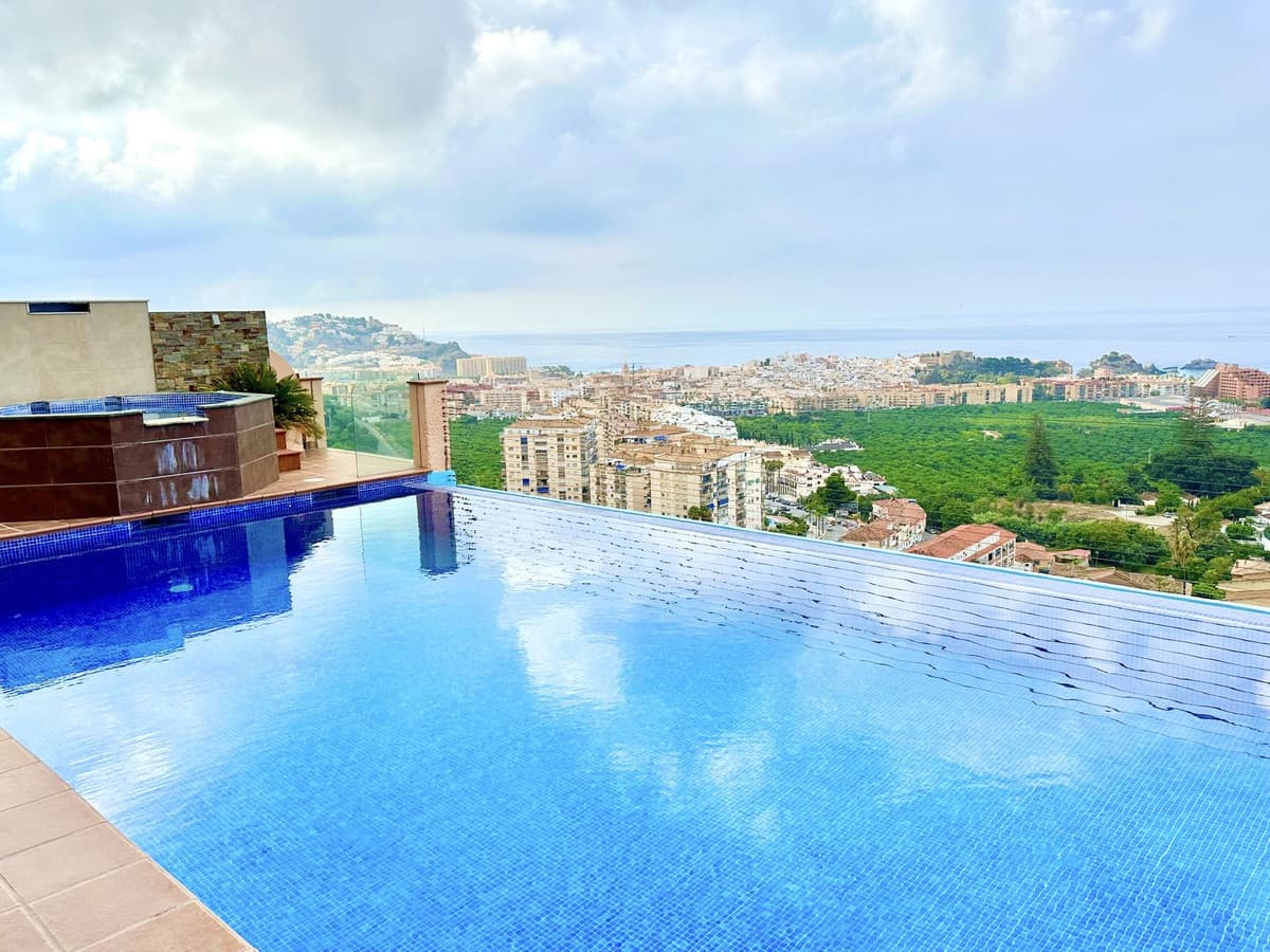 Spectacular villa in Almunecar with stunning panoramic views of the sea and the village, large infinity pool and jacuzzi, both heated, located in one of the best areas of Almunecar.Almuñécar is a coastal town on the Costa Tropical of Granada. Crowned by its Moorish castle, it enjoys an unbeatable location. It is about 45 minutes from Granada, the city of the Alhambra and only 1 hour from the Sierra Nevada Natural Park where you can enjoy the best snow sports while enjoying the good weather. But that's not all, this village is only 1 hour from Malaga International Airport. With an exquisite gastronomy and quiet and beautiful beaches this village can be your best option.This villa consists of 500 meters of built area approximately, on a plot of 850 m2, on the entrance floor has its impressive swimming pool, jacuzzi, cinema screen, barbecue, cinema room, games room (pool table, ping pong, darts) and gym, living room, kitchen, bathroom and bedroom. 1st floor has main living room, big terrace with views, main kitchen, 2 bedrooms, 2 bathrooms. 2nd floor has 3 bedrooms all en suite + turret with another bedroom.All rooms with air conditioning, sustainable housing, generates more energy than it consumes throughout the year. Fiber optic internet.