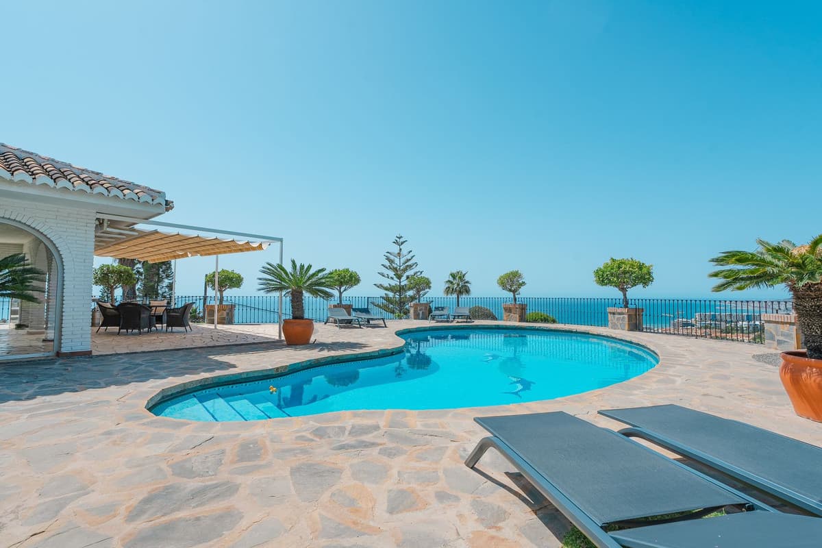 Luxury Villa with Panoramic Sea Views in La Capellanía, Benalmádena4 Bedrooms | 4 Bathrooms | Private Pool | Guest Apartments | Wine Room | Garage | Southwest-FacingThis beautiful villa is located in the exclusive residential area of La Capellanía, set on a very wide southwest-facing plot that offers full privacy, all-day sun, and spectacular sea views.The main house features a bright open-plan layout with a spacious living room, a fully equipped modern kitchen, and two large ensuite bedrooms. Large glass doors connect seamlessly to the terraces, pool, jacuzzi, and garden—creating the perfect setting for outdoor living and entertaining.In addition, the property includes two fully independent guest apartments, each with its own private entrance, kitchen, and bathroom—ideal for family, visitors, or high-yield rental use.The villa also includes a stone wine room, garage with space for two cars, and high-quality finishes throughout. Its southwest orientation ensures natural light all day and unforgettable sunset views over the Mediterranean.Just a short drive to all amenities and close to the beach, this villa offers a perfect combination of lifestyle and investment potential.Whether you’re looking for a permanent residence, a second home, or a rental property, this villa in La Capellanía is a rare opportunity in one of the Costa del Sol’s most sought-after and peaceful areas.Panoramic sea viewsVery private settingTwo guest apartmentsPool and jacuzziWine roomDouble garageProven rental historyContact us for more information or to arrange a private viewing.