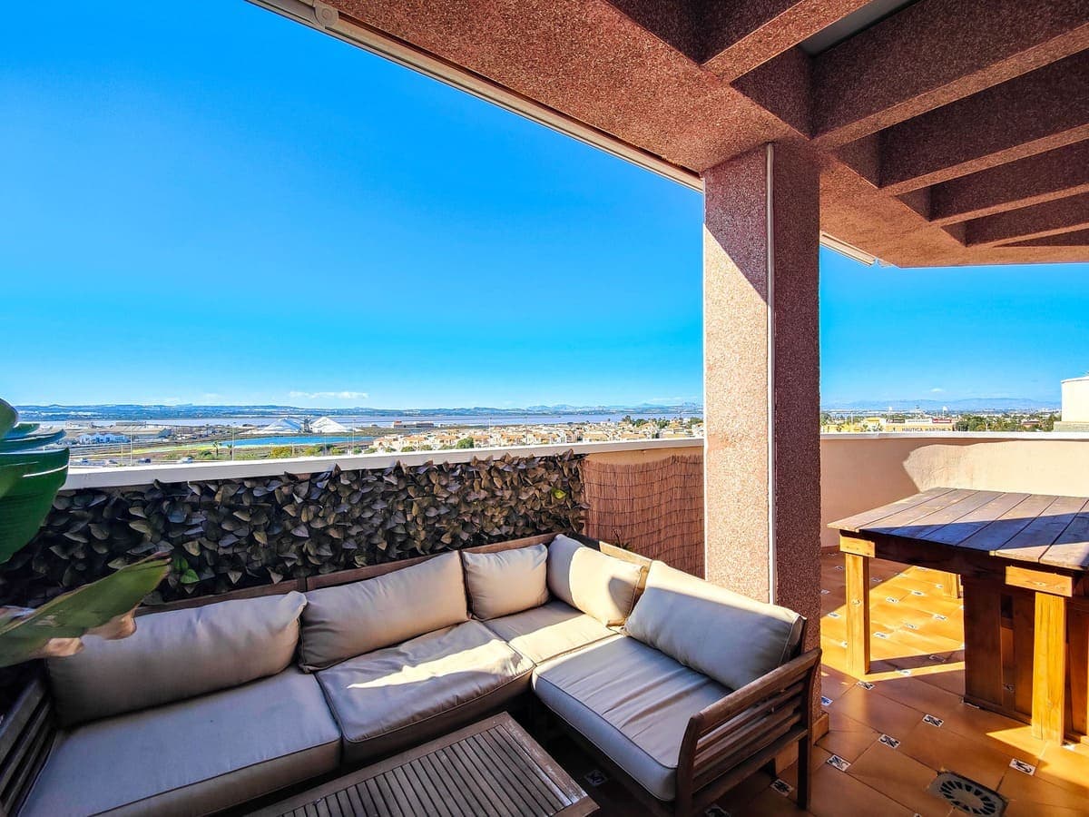 Penthouse for sale with a 40m2 corner terrace near the Parque de las Naciones in Torrevieja.The penthouse lies on the 5th and last floor in a building with an elevator. The penthouse has 3 bedrooms and 2 bathrooms, a modern fitted open plan kitchen with top brand appliances and a bright living room. The penthouse lies on a corner and has a large terrace of 40 square meters in the shape of an L to which all rooms have access. On the terrace there is a storage room and a storage cupboard. From this terrace you can enjoy a beautiful sunset over the salt lakes of Torrevieja. All three bedrooms are air-conditioned. The main room has a built-in wardrobe and an en-suite bathroom.The building lies close to all shops, several restaurants and bars, bus stop, pharmacy, banks etc… The beach and the promenade are within walking distance (1km). Parking is easy on the street (free) and there is also an area next to the building where you can park your car for free.