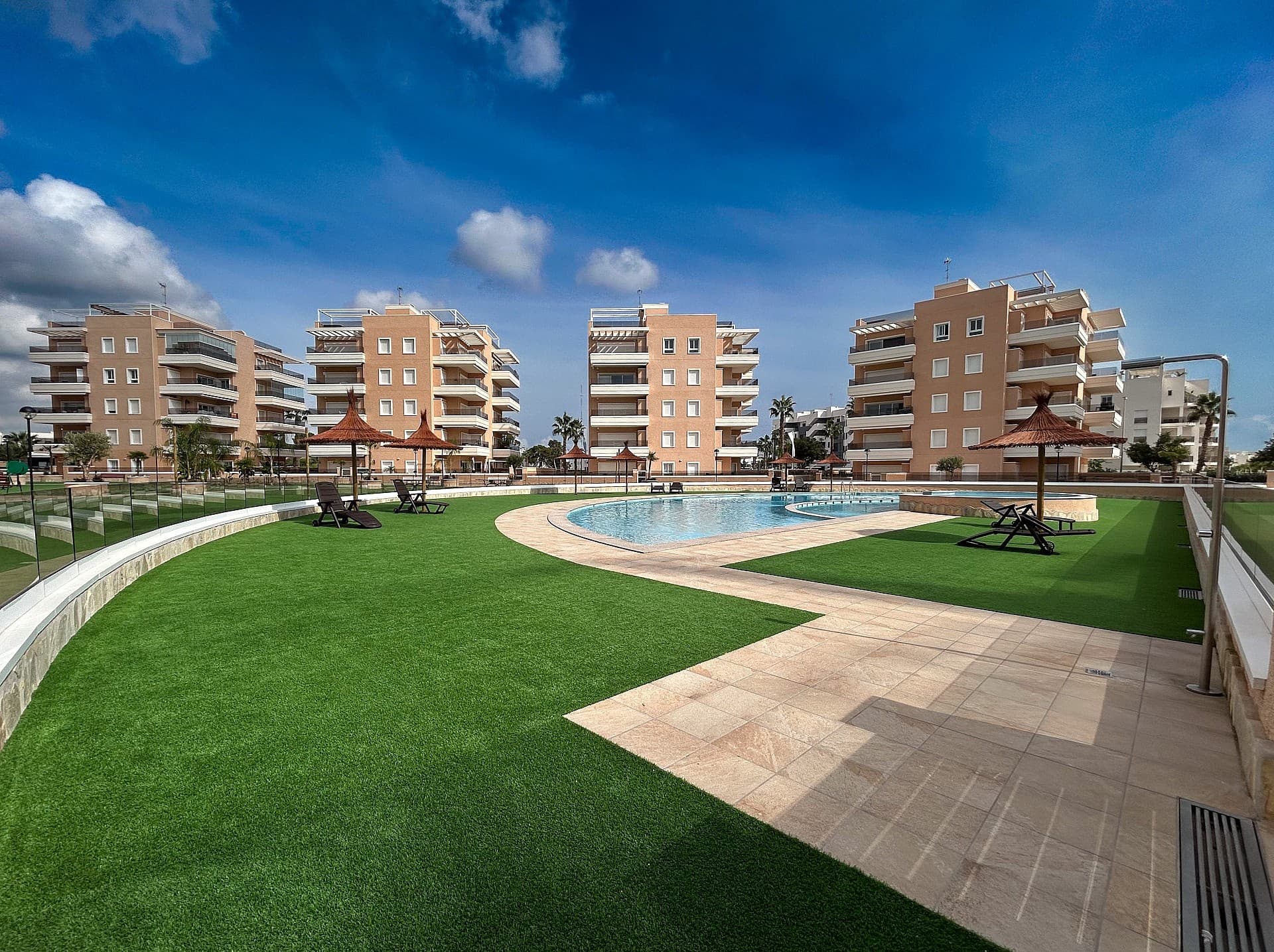 Discover this stunning, recently built, move-in-ready apartment in Vista Azul XXXVII Spa & Nature, a modern residential complex in the popular urbanisation El Raso. Enjoy spectacular panoramic views over the salt lakes, the peaceful natural surroundings, and the proximity to the golden beaches of Guardamar del Segura.LocationGuardamar del Segura is one of the most sought-after seaside towns on the Costa Blanca, famous for its long golden sandy beaches and warm, crystal-clear Mediterranean waters. The town retains an authentic Spanish charm, with cosy restaurants, a lively promenade, and a pleasant town centre where you can enjoy sun, sea and local gastronomy all year round.In the immediate area you’ll find shops, supermarkets, bars, restaurants, several golf courses and beautiful sandy beaches. The complex also borders a protected nature reserve, perfect for walking and cycling, and known as a resting spot for thousands of migratory birds, including flamingos.The complexVista Azul XXXVII is a gated residential community offering a wide range of facilities designed for relaxation and comfort:Large outdoor swimming pool with children’s pool and jacuzziWellness area with heated indoor pool and saunaOutdoor fitness areaChildren’s play zonePetanque courts and a putting greenBeautifully maintained green areas for peace and relaxationThe apartmentThe property is as good as new, having been very lightly used by the current owners.It’s ideal as a holiday home or for permanent living under the Spanish sun.Located on the second floor (with lift) and south-east facing, the apartment enjoys plenty of natural light thanks to large windows and a spacious terrace.The layout includes:A bright living room with sliding doors to the terraceA modern open-plan kitchen with built-in appliances and breakfast barThree bedrooms with fitted wardrobesTwo elegant bathrooms, one of which is en-suiteAdditional storage space in the hallway and on the terraceFeatures & extrasPrivate parking space in the underground garage (included)Storage room on the terrace with boiler and washing machineElectric shutters throughout the apartmentCentral air conditioning (hot and cold)Automatic sun awning on the terraceHigh-quality finishes and modern décorFurniture and decoration included in the price, making it completely move-in readyDon’t miss this opportunity to experience the Mediterranean lifestyle under the Spanish sun.Book your viewing today – this apartment truly needs to be seen!