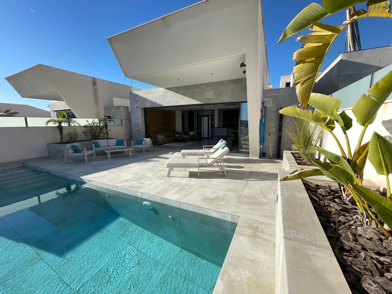 Welcome to your own little piece of paradise!Where modern luxury, ultimate comfort and tranquillity find a perfect coherence with contemporary design in beautiful surroundings.This luxurious villa is finished with the highest quality materials and very strategically located at one of the highest points in Rojales - Ciudad Quesada, allowing you to enjoy breathtaking views of the Mediterranean Sea and the Skyline of Guardamar del Segura all year round, very centrally located just a few minutes' drive from the vibrant town of Rojales and only a 2-minute drive to the prestigious Marquesa Golf.You enter the spacious living area with beautiful, open-plan kitchen that flows seamlessly into the large terrace with large infinity pool, where you can enjoy the incredible views. In addition, you also have a two spacious bedrooms, both with ensuite bathrooms. The external staircase leads to the solarium, where you can enjoy the magic of the Costa Blanca!On the ground floor, you can find two more spacious bedrooms with bathrooms, a garage with charging point (together with 40 solar panels and home battery that make the house energy-neutral ) and a fully equiped gym! There is also a laundry room with washing machine and dryer.This villa is keyready and is sold fully furnished. Don't miss this great opportunity and book your viewing now!