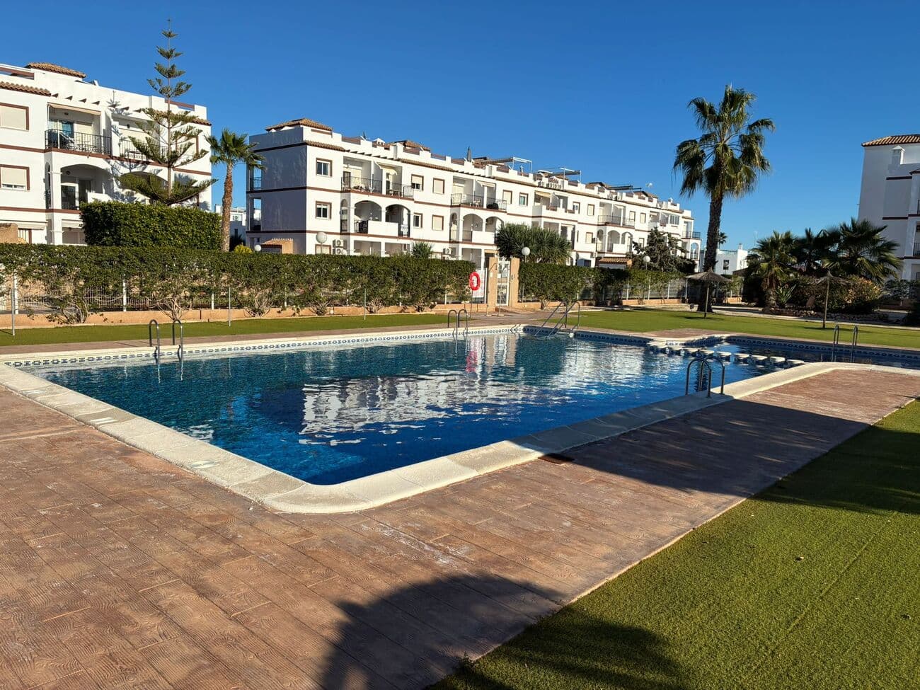 This beautiful apartment offers an exceptional opportunity to enjoy coastal living just 900 metres from the Mediterranean Sea, in the popular area of Punta Prima, Orihuela Costa. Located on the ground floor of a residential complex built in 2008, the property combines comfort, convenience and strong investment potential.With a total built area of 66 m², the apartment features a bright and functional layout, comprising:2 spacious bedrooms2 fully equipped bathroomsOpen-plan living and dining area with plenty of natural light and direct access to the terrace and gardenModern, fully fitted kitchenPrivate garden of 53 m², ideal for sunbathing, outdoor dining or relaxingAdditional features include a fully furnished interior and a private parking space within the complex. Residents benefit from access to a communal swimming pool and enjoy a peaceful, secure environment within a gated community.The apartment is in excellent condition and ready to move into.Thanks to its quiet yet central location, all essential amenities are within walking distance, including supermarkets, restaurants, pharmacies and public transport links. The beach and the popular Zenia Boulevard shopping centre are also just a few minutes away.This property is ideal as a permanent residence, a holiday home, or a high-yield rental investment, offering a low-maintenance lifestyle in one of the most desirable areas of the Costa Blanca.Contact us today to arrange a viewing.
