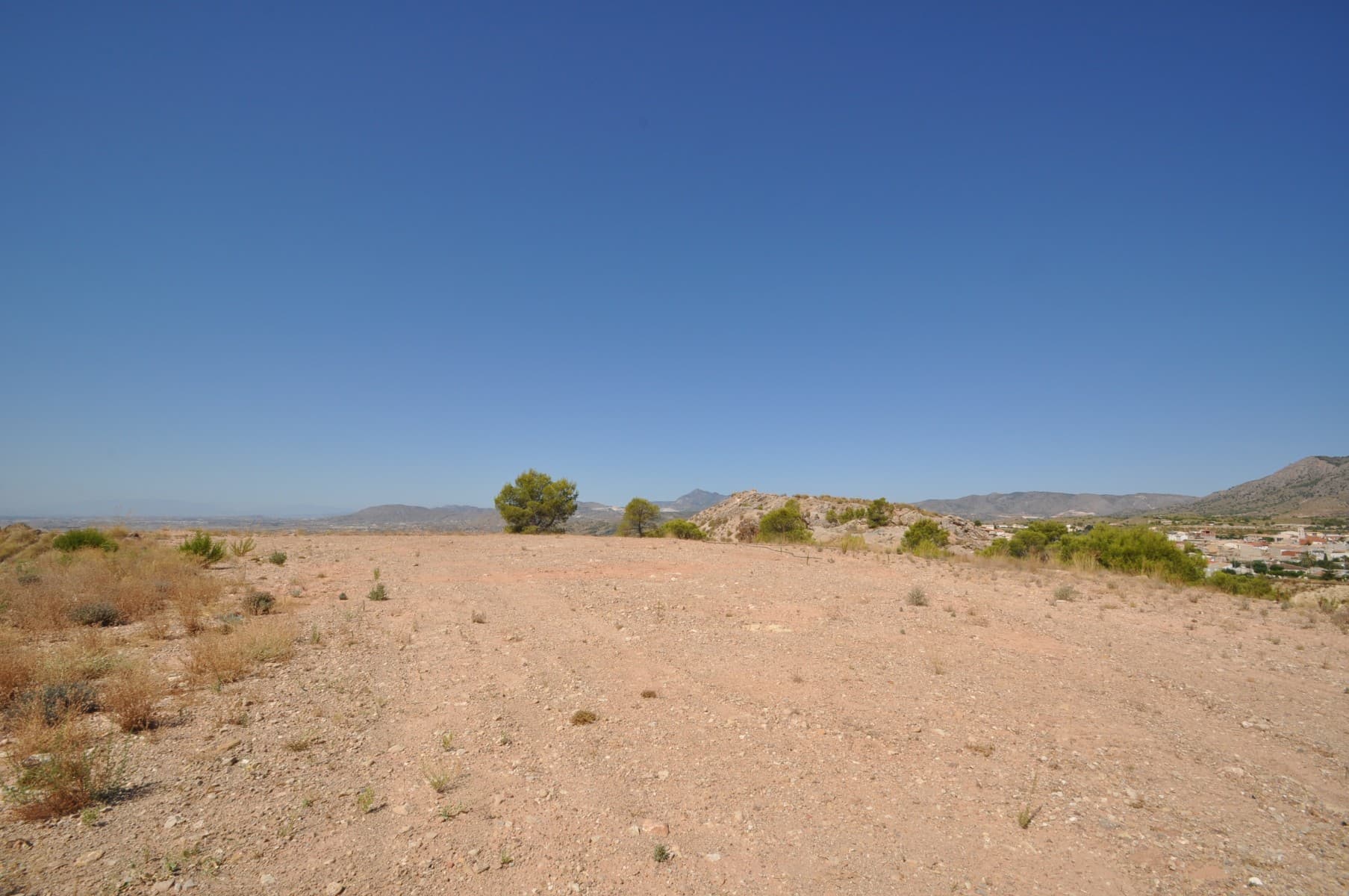 This is a great opportunity to pick up a elevated plot offering spectacular views over the surrounding vineyards, orchards and mountain ranges. The views are very far ranging I will offer spectacular sun rises and sunsets. The plot benefits from being very close to the town add comes with the services of water and electric included in the price. We have been living and working in the area since 2004 and as such can help you with every aspect of the design and build stages.We are specialists in the Costa Blanca and Costa Calida specialising in the Alicante and Murcia Inland regions with a particular emphasis on Elda, Pinoso, Aspe, Elche and surrounding areas. We are an established, well known and trusted company that has built a solid reputation amongst buyers and sellers since we began trading in 2004. We offer a complete service with no hidden charges or surprises, starting with sourcing the property, right through to completion, and an unrivalled after sales service which includes property management, building services, and general help and advice to make your new house a home. With a portfolio of well over 1400 properties for sale, we are confident that we can help, so just let us know your preferred property, budget and location, and we will do the rest.