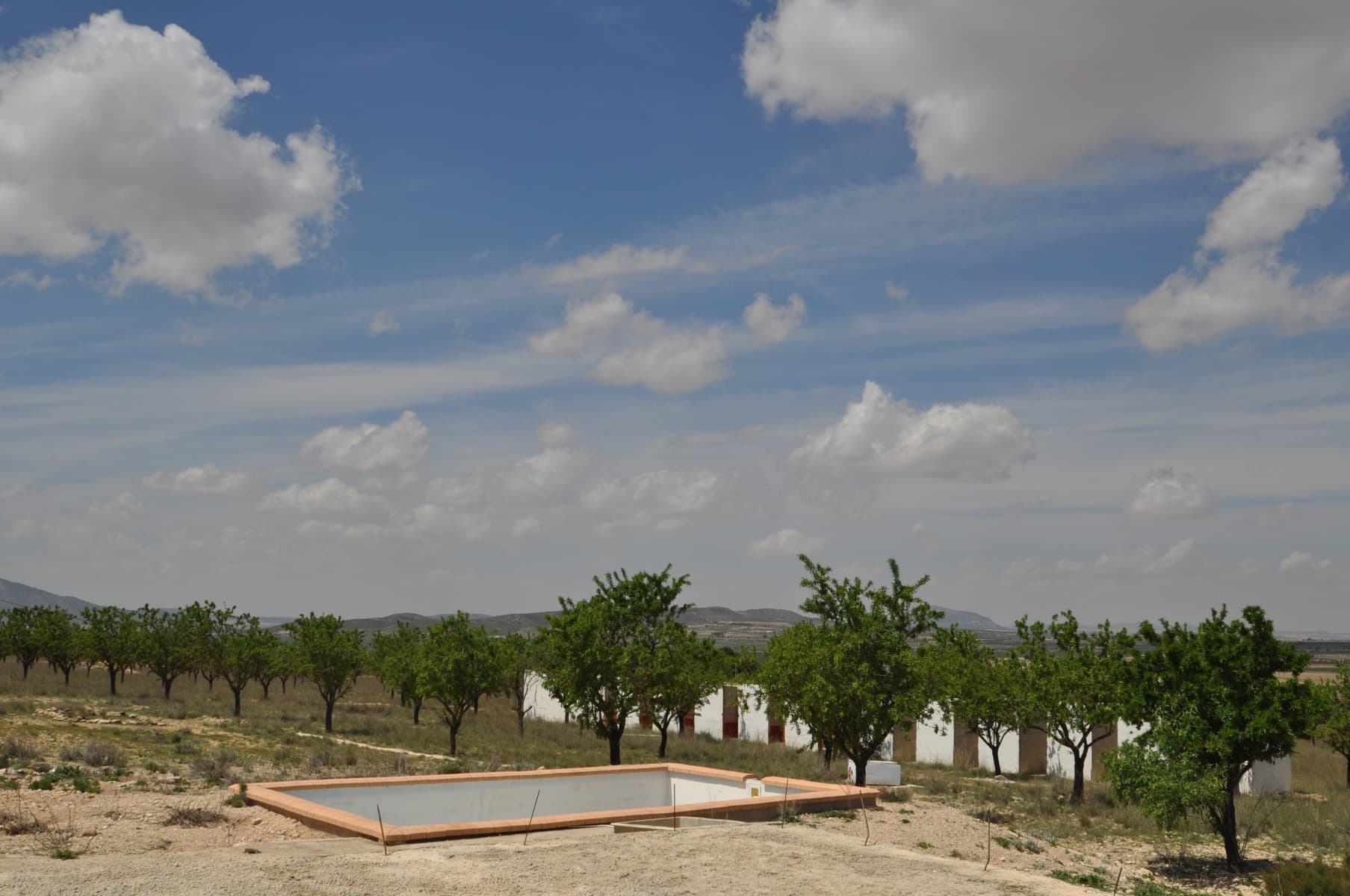 Please note the buildings etc on the photos have now been stripped, therefore leading to the reduction in priceThis is a rare opportunity to pick up a potential business... It is a plot of approx 25,000m2 planted with almond trees and with mains electric and water from a bore hole drilled on the land at an expense of € 12,000. Further more the owner has built a swimming pool, laid a base for a house next to the existing casita and built 12/13 dog kennels with a fenced in area for the dogs to run around in - they actually ran boarding kennels from there. There are no license for any of the above (apart from the casita which has existed for a long time), but the town hall have confirmed that there are no fines due and as long as the new owners apply for a license for the pool then all will be well. They have also indicated that a boarding kennels type facility could be run from that plot with the right licenses. A great buy for someone looking to build their own home and run a business. This property has been greatly reduced because everything has been strippd from the property. Great opportunity for somoene.We are specialists in the Costa Blanca and Costa Calida specialising in the Alicante and Murcia Inland regions with a particular emphasis on Elda, Pinoso, Aspe, Elche and surrounding areas. We are an established, well known and trusted company that has built a solid reputation amongst buyers and sellers since we began trading in 2004. We offer a complete service with no hidden charges or surprises, starting with sourcing the property, right through to completion, and an unrivalled after sales service which includes property management, building services, and general help and advice to make your new house a home. With a portfolio of well over 1400 properties for sale, we are confident that we can help, so just let us know your preferred property, budget and location, and we will do the rest.