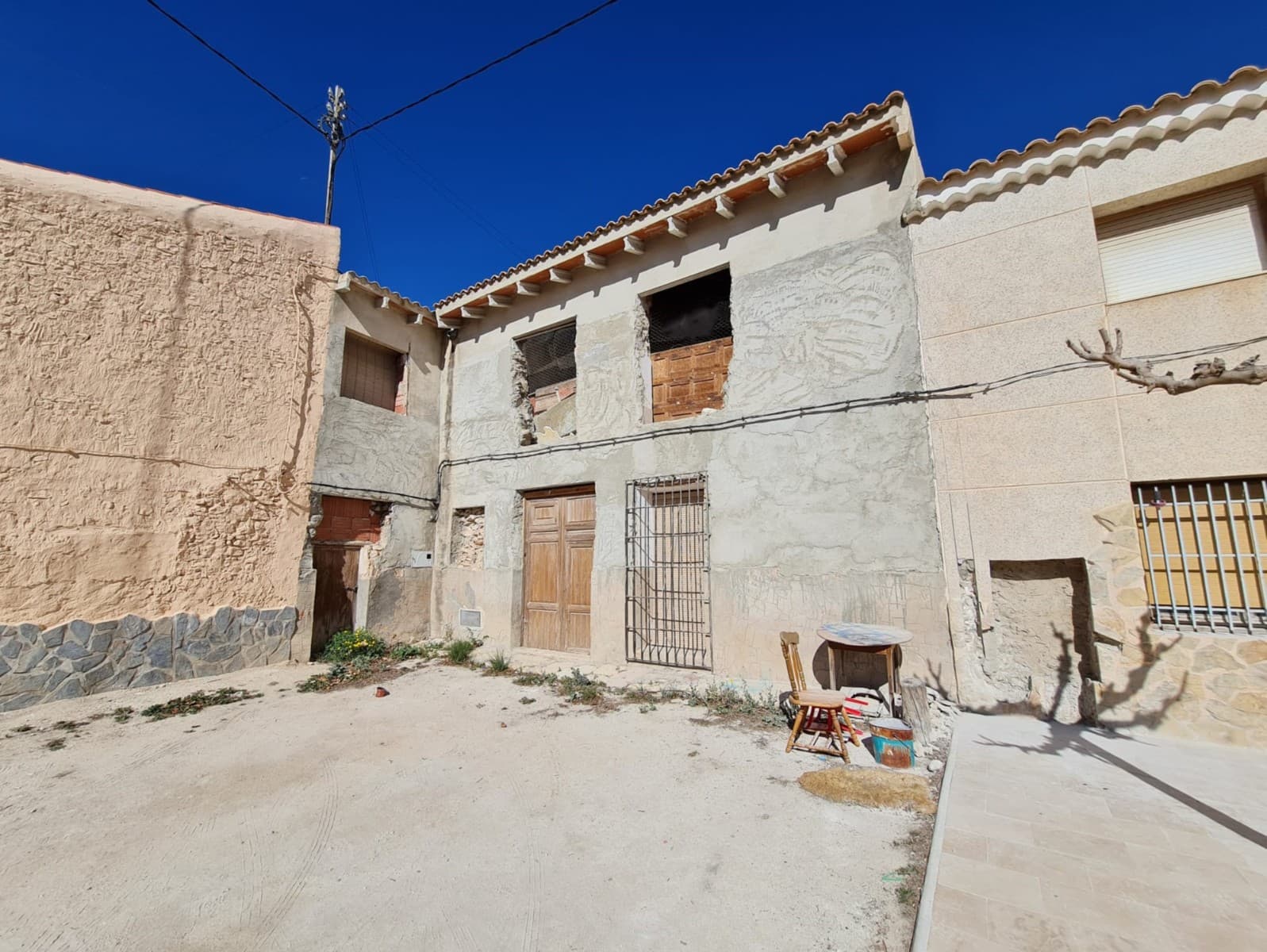 Welcome to a promising investment opportunity in the charming countryside near Pinoso! This village house, nestled in a quaint hamlet, presents an exciting prospect for those with a vision for renovation. Boasting 6 potential bedrooms and 3 bathrooms, this property spans across two floors, offering ample space to craft a comfortable living environment.With mains electricity and drinking water already in place, the groundwork is set for transforming this house into a cosy retreat or a lucrative rental property. The property's standout feature is its large bodega, complete with wine pits and a press, providing a unique touch of character.Outside, a spacious enclosed garden awaits, offering a tranquil outdoor space for relaxation or entertaining. Additionally, the purchase includes a plot of 1000m2 a few metres away, along with a small plot in front of the house, further enhancing the potential of this countryside gem.Furthermore, with its generous layout, this property could be split into 3 separate apartments, offering versatility for rental income or multi-generational living arrangements.Embrace the opportunity to revitalise this village house into a charming residence or investment property. Arrange a viewing today and unlock the hidden potential of this countryside gem in a truly charming location.We have a large portfolio of properties in the Costa Blanca and Costa Calida areas, specialising in country properties, villas, fincas, building plots and design and build options in the Alicante and Murcia regions with a particular emphasis on Elda, Monovar, Pinoso, Sax, Villena, Aspe, Fortuna, Albacete and many more surrounding areas. We have been established since 2004 and have decades of experience between the team which we bring to bear to help you find and secure your new dream home. We help you every step of the way to make sure your purchase in Spain is safe and hassle free. We are not here to sell you a property, we are here to help you realise your dream and find what is right for you. With us you are in the safest hands. Contact us now to have a no obligation chat about how you too can realise your dreams.