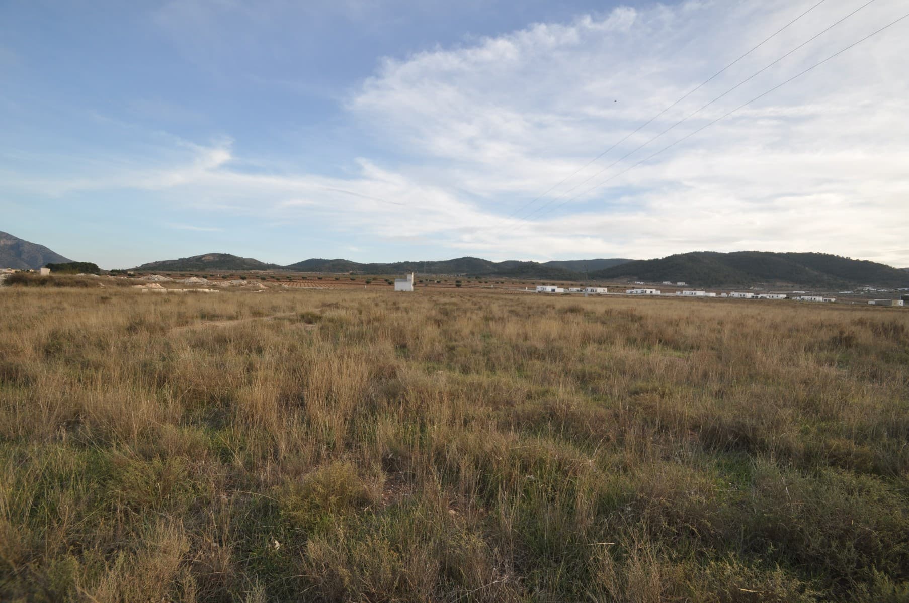 This is a fully legal building plot located approximately 7 minutes outside the town of Pinoso. The plot is located a short distance from the village and has both water and electric very close to it - neither should be too difficult or expensive to connect. If you are interested, we can help you obtain quotes as a condition of purchase. On this plot you can build a house of 250 square metres on the one level or you can build a two level house with 200 square metres per floor giving you a total build area of 400 square metres. The great thing about this plot is that it is within walking distance to the local village which has a bar and restaurant. Your main day today facilities will be in the town of Pinoso which is approximately 7 minutes away where you can find supermarkets, bars, restaurants, shops, et cetera. We have been designing and building homes in the area since 2004 and as such we have a wealth of knowledge and experience which we can bring to bear in helping you to realise your new dream home. We help you as much or as little as you want, from just buying the plot to helping you with planning permission to actually project managing the build for you. We have over 150 plots, if you would like to arrange to view this plot and other ideas then please do not hesitate to contact us. We look forward to helping you get a step closer to realising your dream.We have a large portfolio of properties in the Costa Blanca and Costa Calida areas, specialising in country properties, villas, fincas, building plots and design and build options in the Alicante and Murcia regions with a particular emphasis on Elda, Monovar, Pinoso, Sax, Villena, Aspe, Fortuna, Albacete and many more surrounding areas. We have been established since 2004 and have decades of experience between the team which we bring to bear to help you find and secure your new dream home. We help you every step of the way to make sure your purchase in Spain is safe and hassle free. We are not here to sell you a property, we are here to help you realise your dream and find what is right for you. With us you are in the safest hands. Contact us now to have a no obligation chat about how you too can realise your dreams.
