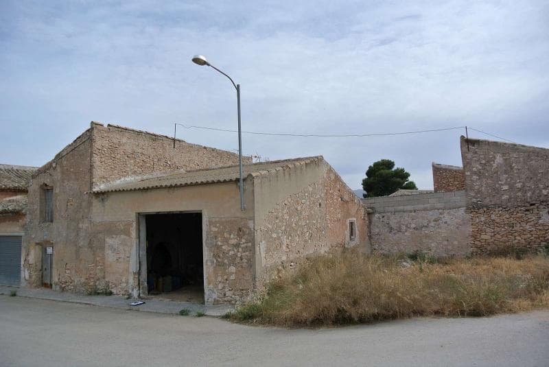 This property is located in the heart of a small village which has now been urbanised. This means that the property can be fully developed and restored into a family home. Currently the property is a large garage and a two-storey Bodega/storeroom. The side of the property is a garden area which is approximately 70 m². Property benefits from a nice location with tarmac access and has the facilities of mains water, electric and mains sewage available on its doorstep. In addition, it has open views to the small villages green area and then open fields with orchards and vineyards. It has great investment possibility especially at the current price!We are specialists in the Costa Blanca and Costa Calida specialising in the Alicante and Murcia Inland regions with a particular emphasis on Elda, Pinoso, Aspe, Elche and surrounding areas. We are an established, well known and trusted company that has built a solid reputation amongst buyers and sellers since we began trading in 2004. We offer a complete service with no hidden charges or surprises, starting with sourcing the property, right through to completion, and an unrivalled after sales service which includes property management, building services, and general help and advice to make your new house a home. With a portfolio of well over 1400 properties for sale, we are confident that we can help, so just let us know your preferred property, budget and location, and we will do the rest.