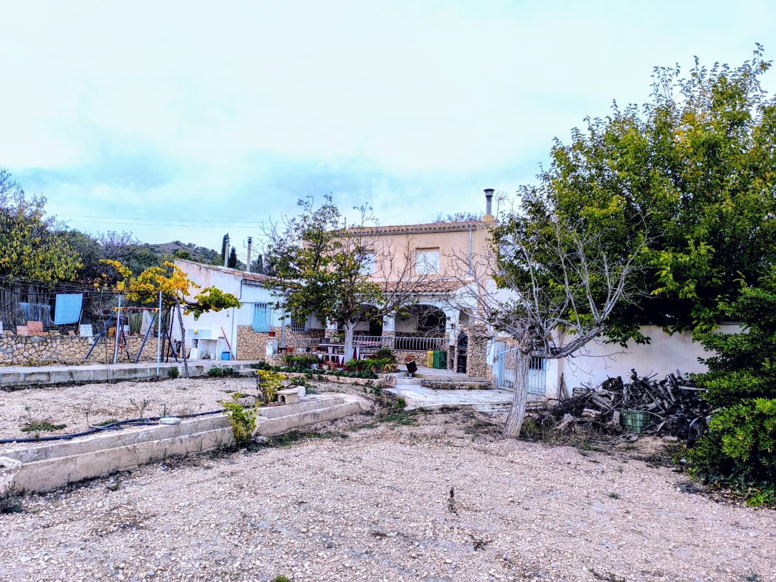 Large country villa for sale! Located in a little settlement, 12 km from Yecla, this property offers a tranquil countryside retreat with a combination of traditional charm and modern comfort. The house is spread over 2 floors. Downstairs you will find a large living room with a bar and a fireplace, perfect for relaxation, parties, and family gatherings, an equipped independent kitchen, a bathroom, a storage, and two bedrooms. Upstairs there are 4 spacious bedrooms with views over the surrounding countryside. Furthermore, the property boasts a large garage with another fireplace.Outside space is designed for embracing a slow Spanish lifestyle: comfortable, shaded terrace for sitting with friends, BBQ area with traditional stone oven, garden with irrigation system and beautiful views for gardening, and a large, private pool. Extra features are a tool shed and an outside bathroom.Though mildly old, the house has been well-cared for and offers great potential for customization to suit your personal preferences. Thanks to its size, it could host a large family or many guests. The total built area of 286m2 allows for various possibilities in terms of creating functional living spaces and adapting the property to your lifestyle.The villa is situated in an expat-friendly settlement, with neighbours not too close, offering enough privacy. Access is with a convenient tarmac road, house is connected both to mains electric and irrigation water. Don't hesitate to contact us to see it!About the area: Yecla is a charming and historic town of app. 35000 inhabitants, located in the region of Murcia. It is renowned for its award-winning wines, historical landmarks, and vibrant local culture. The surrounding natural landscapes of scenic mountains, vineyards and almond groves provide opportunities for outdoor activities, while the town itself offers all necessary services, including hospital, schools, shops, restaurants, and other services. With a friendly local community, lively markets, excellent gastronomy, and easy access to nature, Yecla is an ideal location for those seeking authentic Spanish lifestyle - just about an hour from the coast and Alicante airport.About us: We have a large portfolio of properties in the Costa Blanca and Costa Calida areas, specialising in country properties, villas, fincas, building plots and design and build options in the Alicante and Murcia regions with a particular emphasis on Elda, Monovar, Pinoso, Sax, Villena, Aspe, Fortuna, Albacete and many more surrounding areas. We have been established since 2004 and have decades of experience between the team which we bring to bear to help you find and secure your new dream home. We help you every step of the way to make sure your purchase in Spain is safe and hassle free. We are not here to sell you a property, we are here to help you realise your dream and find what is right for you. With us you are in the safest hands. Contact us now to have a no obligation chat about how you too can realise your dreams.