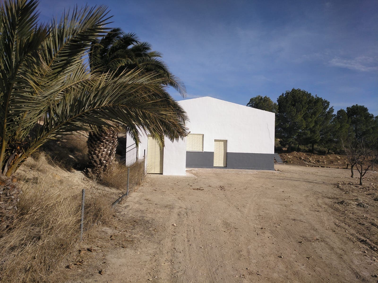This property offers a versatile combination of warehouse space and agricultural land just 8 km from the town of Yecla. The site includes a warehouse and roughly 60,000 m² of open, vacant land, suitable for various agricultural, storage, or development uses. In addition, a separate 15,000 m² plot is planted with mature olive trees and features water access points, including 4 registered water actions, providing a reliable supply for irrigation or other needs. This setup is ideal for agricultural use, a storage hub, or even a rural business project.The property is located near Yecla, a town known for its wine production, furniture industry, and surrounding natural landscapes. Yecla offers all the necessary services including shops, restaurants, schools, and healthcare. With convenient road access and a peaceful rural setting, the location combines privacy with practicality.We have a large portfolio of properties in the Costa Blanca and Costa Calida areas, specialising in country properties, villas, fincas, building plots and design and build options in the Alicante and Murcia regions with a particular emphasis on Elda, Monovar, Pinoso, Sax, Villena, Aspe, Fortuna, Albacete and many more surrounding areas. We have been established since 2004 and have decades of experience between the team which we bring to bear to help you find and secure your new dream home. We help you every step of the way to make sure your purchase in Spain is safe and hassle free. We are not here to sell you a property, we are here to help you realise your dream and find what is right for you. With us you are in the safest hands. Contact us now to have a no obligation chat about how you too can realise your dreams.