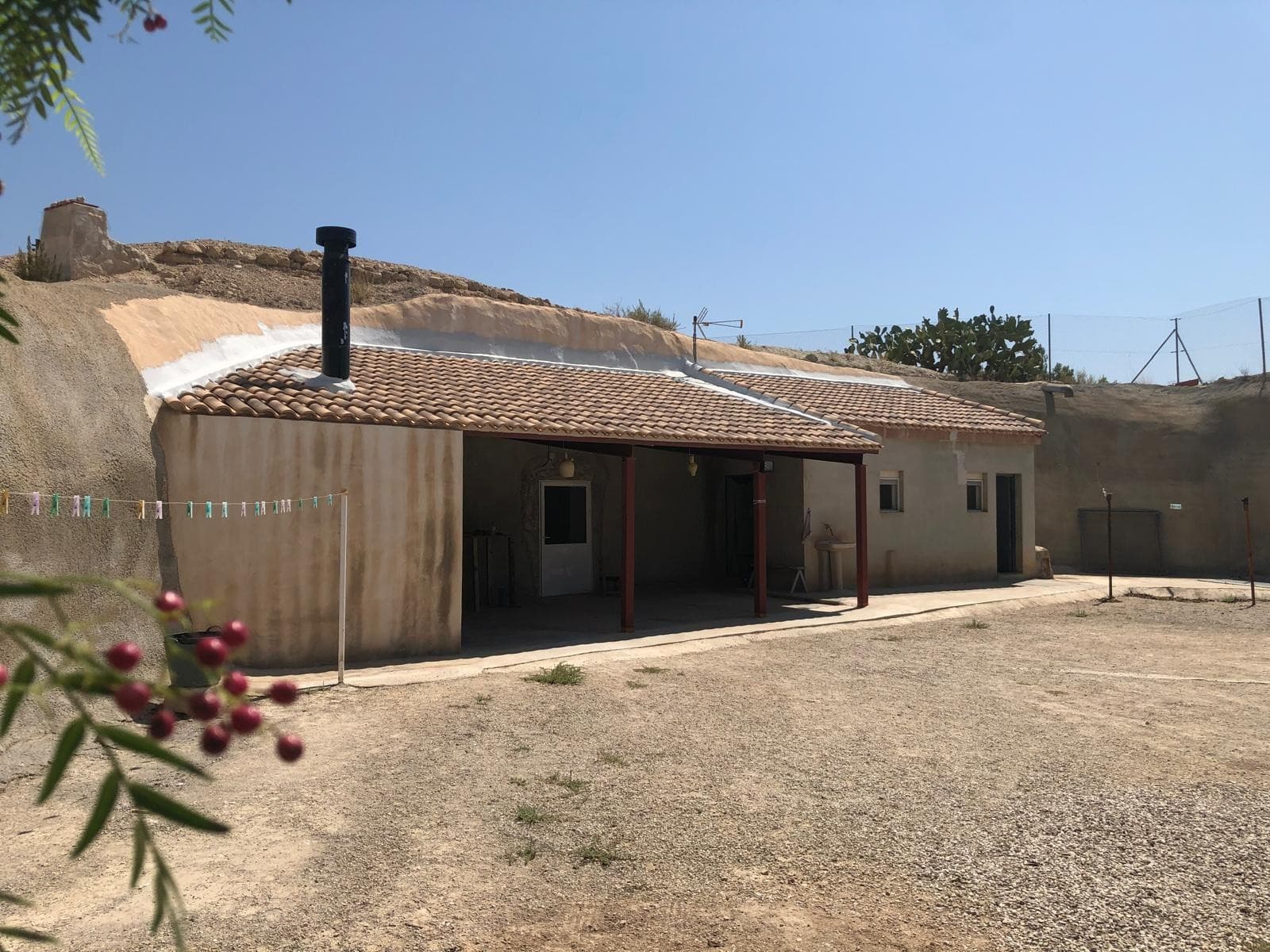 This charming cave house, set on a 13,322 m² plot near Abanilla, Murcia, offers a unique blend of rustic living and modern conveniences. The home features 2 bedrooms, a full bathroom, a spacious open-plan living room with kitchen, a hall, and a storage room. The property is fully equipped with drinking water, electricity, a septic tank, and is surrounded by a fenced plot. For outdoor living, the house includes a barbecue area, and the grounds are home to a variety of fruit trees such as almond, fig, pomegranate, and plum trees. Additional amenities include a chicken coop, making this an ideal choice for those looking to enjoy a tranquil, self-sufficient lifestyle.The Area:Located near the town of Abanilla in Murcia, this property enjoys a peaceful rural setting with stunning natural beauty. Abanilla is known for its agricultural heritage, particularly olive and almond groves, and offers a laid-back way of life. The town provides essential services and is within easy reach of larger towns for additional amenities. The region is also famous for its warm climate, making it an excellent place to live year-round or to establish a peaceful retreat.We have a large portfolio of properties in the Costa Blanca and Costa Calida areas, specialising in country properties, villas, fincas, building plots and design and build options in the Alicante and Murcia regions with a particular emphasis on Elda, Monovar, Pinoso, Sax, Villena, Aspe, Fortuna, Albacete and many more surrounding areas. We have been established since 2004 and have decades of experience between the team which we bring to bear to help you find and secure your new dream home. We help you every step of the way to make sure your purchase in Spain is safe and hassle free. We are not here to sell you a property, we are here to help you realise your dream and find what is right for you. With us you are in the safest hands. Contact us now to have a no obligation chat about how you too can realise your dreams.