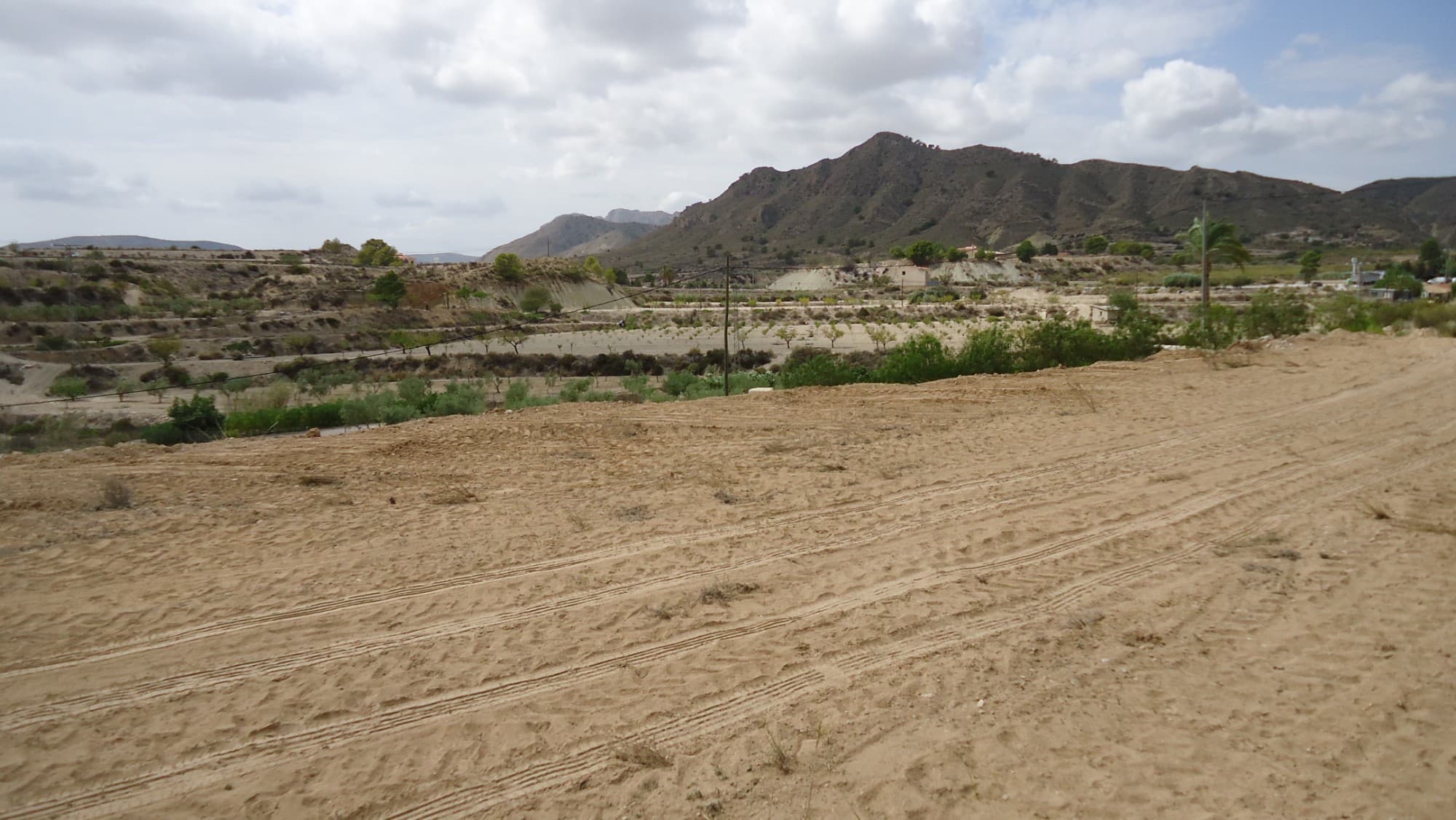 This 7,477 m² plot in Abanilla offers a peaceful setting with stunning views of the surrounding mountainous landscape. The land is suitable for building a 20 m² shelter with a 20 m² porch, or for installing a mobile home or caravan, providing flexibility for those looking to create a retreat or vacation spot. The plot includes olive trees and benefits from irrigation water, with the possibility of connecting to drinking water and electricity. Access is convenient, with a paved road leading up to just 150 meters from the property.The Area:Located near the charming towns of Mahoya and Abanilla, this plot combines rural tranquility with easy access to local amenities. Abanilla is known for its rich cultural heritage and natural beauty, with scenic views and hiking trails. The nearby town of Mahoya offers restaurants, shops, and essential services, making it a convenient location for both relaxation and daily needs. This property is ideal for those seeking a quiet retreat while staying connected to the local community.We have a large portfolio of properties in the Costa Blanca and Costa Calida areas, specialising in country properties, villas, fincas, building plots and design and build options in the Alicante and Murcia regions with a particular emphasis on Elda, Monovar, Pinoso, Sax, Villena, Aspe, Fortuna, Albacete and many more surrounding areas. We have been established since 2004 and have decades of experience between the team which we bring to bear to help you find and secure your new dream home. We help you every step of the way to make sure your purchase in Spain is safe and hassle free. We are not here to sell you a property, we are here to help you realise your dream and find what is right for you. With us you are in the safest hands. Contact us now to have a no obligation chat about how you too can realise your dreams.