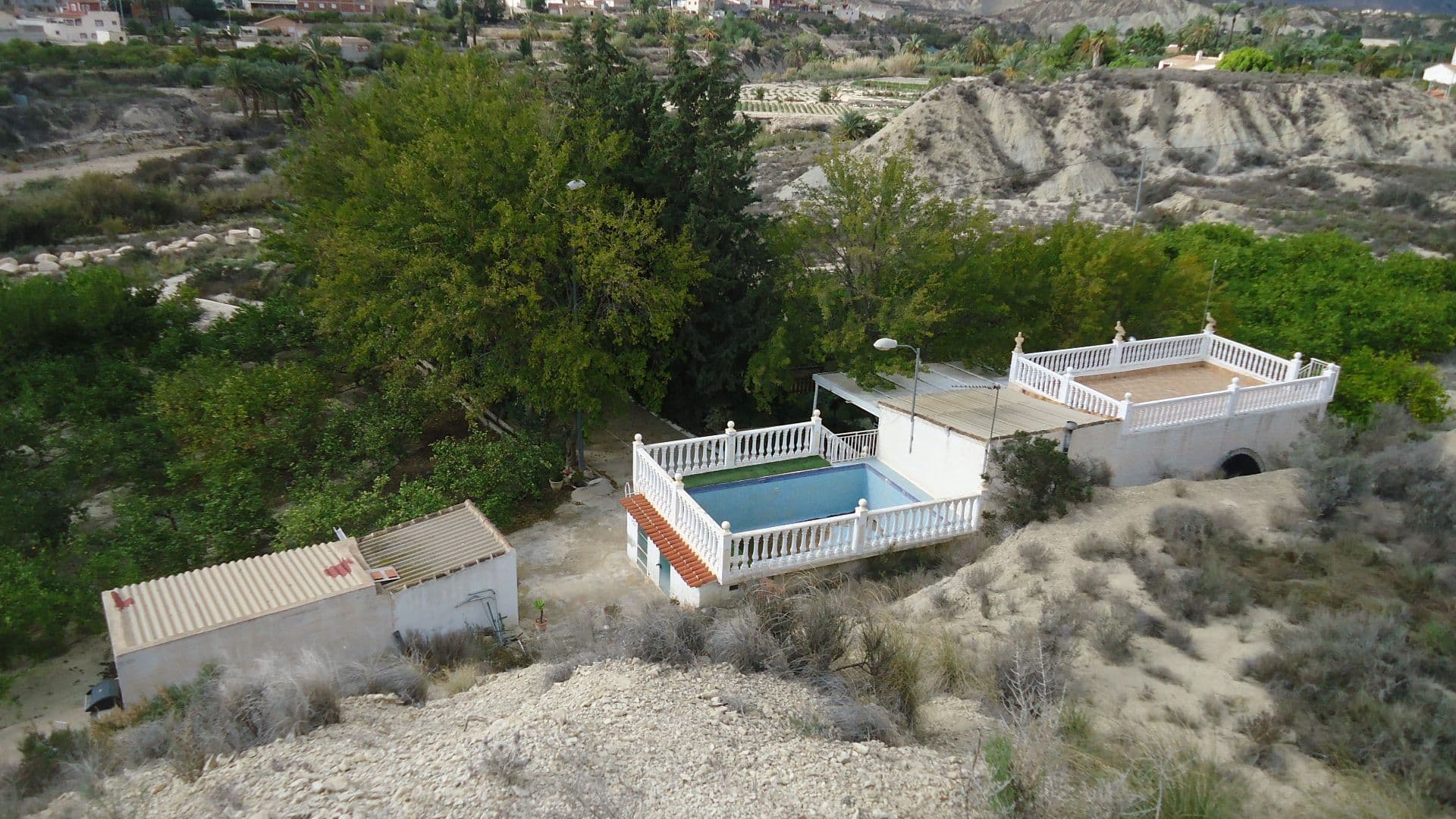 House with Pool and Lemon Grove on a 9,012 m² Plot Near AbanillaDiscover this lovely 100 m² country house set in a peaceful 9,012 m² estate, nestled close to the Chicamo River and just a short drive from the charming towns of Mahoya and Abanilla. The house features a spacious open-plan living room and kitchen, ideal for family gatherings, as well as two cozy bedrooms and a full bathroom. The layout is designed for comfort and practicality, offering everything you need for a relaxed lifestyle.Outside, the property boasts a large terrace and a front porch, perfect for enjoying your morning coffee or soaking in the panoramic views. The private swimming pool offers a refreshing escape on warm days, and the barbecue area is ideal for hosting outdoor meals. A tool shed provides ample storage space for gardening and maintenance equipment.The property comes with essential services, including electricity, drinking water, and irrigation water, ensuring all the conveniences needed for a comfortable life. The highlight of the estate is its 6,000 m² of lemon trees, currently in full production, with an impressive annual yield of 20,000 to 40,000 kg. The efficient irrigation system helps maximize productivity, making this a great opportunity for those interested in farming or simply enjoying the fresh produce.About the Area:Located in a tranquil setting near the Chicamo River, this property offers the perfect blend of rural charm and convenience. The nearby towns of Mahoya and Abanilla provide access to shops, restaurants, and essential services, while the surrounding landscape features stunning natural beauty, with rolling hills and lush greenery. The area is known for its agricultural heritage and is popular with nature lovers and those seeking a peaceful, slower-paced lifestyle. This property is a great choice for anyone looking to enjoy the serenity of country living while staying connected to the local community.We have a large portfolio of properties in the Costa Blanca and Costa Calida areas, specialising in country properties, villas, fincas, building plots and design and build options in the Alicante and Murcia regions with a particular emphasis on Elda, Monovar, Pinoso, Sax, Villena, Aspe, Fortuna, Albacete and many more surrounding areas. We have been established since 2004 and have decades of experience between the team which we bring to bear to help you find and secure your new dream home. We help you every step of the way to make sure your purchase in Spain is safe and hassle free. We are not here to sell you a property, we are here to help you realise your dream and find what is right for you. With us you are in the safest hands. Contact us now to have a no obligation chat about how you too can realise your dreams.