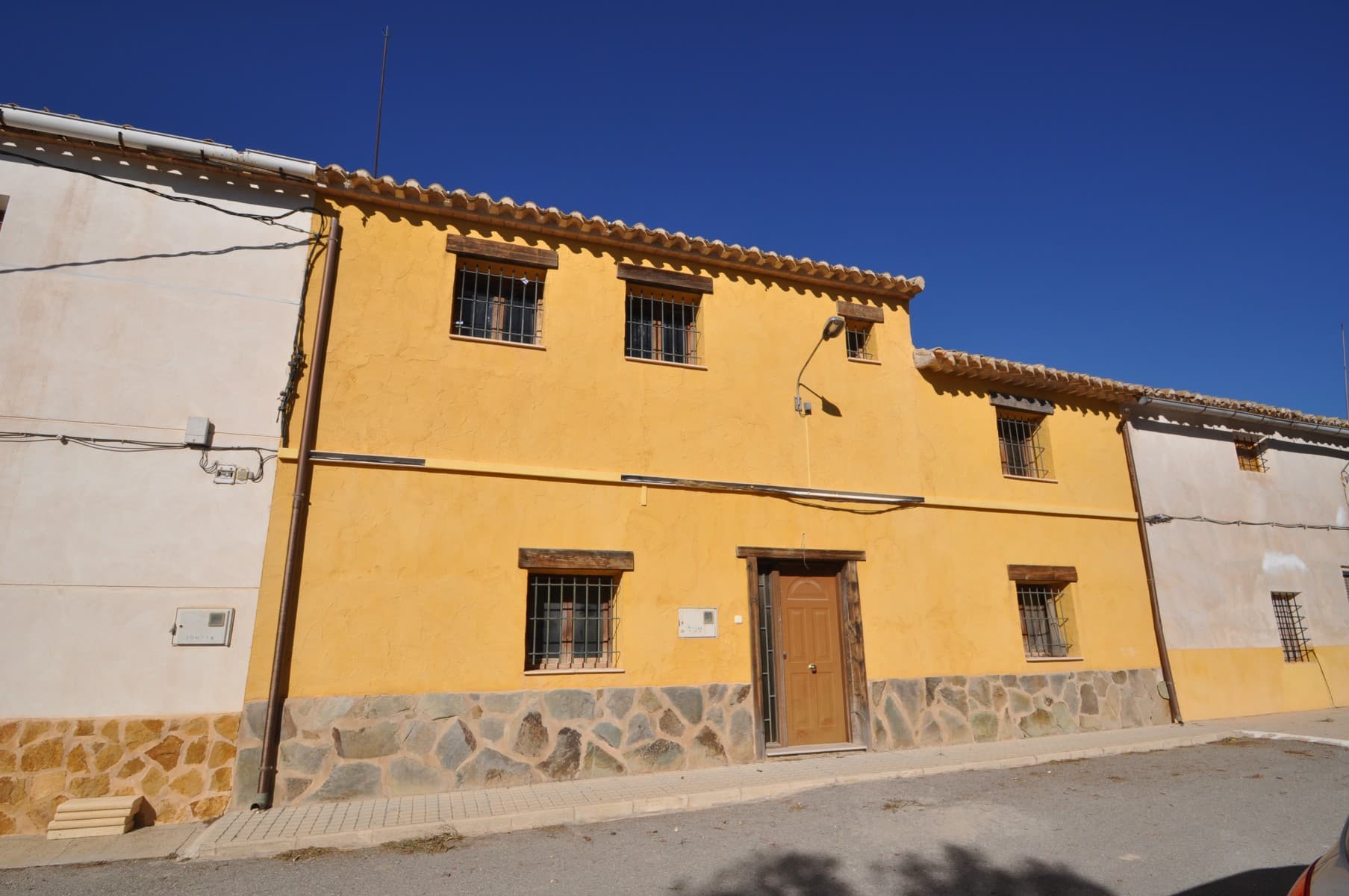 This is a gorgeous village house. There is a large hallway to enter the property. it is well finished with wooden beams and high ceilings. there are two lovely vaulted bedrooms with shutter windows with traditional terracota tiling throughout. There is a large charming lounge with a lovely open fireplace. There is a lovely large private courtyard where a swimming pool could be installed.The property has a new roof and has been fully renovated. There are amazing views. there is a beautiful traditional staircase to the upstairs where there is a large master bedroom with wooden beams. around 28m2. there are three tradional shuttered windows as well as another mezzanine bedroom plus the landing of 3x4 for an office or chill out area.We are specialists in the Costa Blanca and Costa Calida specialising in the Alicante and Murcia Inland regions with a particular emphasis on Elda, Pinoso, Aspe, Elche and surrounding areas. We are an established, well known and trusted company that has built a solid reputation amongst buyers and sellers since we began trading in 2004. We offer a complete service with no hidden charges or surprises, starting with sourcing the property, right through to completion, and an unrivalled after sales service which includes property management, building services, and general help and advice to make your new house a home. With a portfolio of well over 1400 properties for sale, we are confident that we can help, so just let us know your preferred property, budget and location, and we will do the rest.