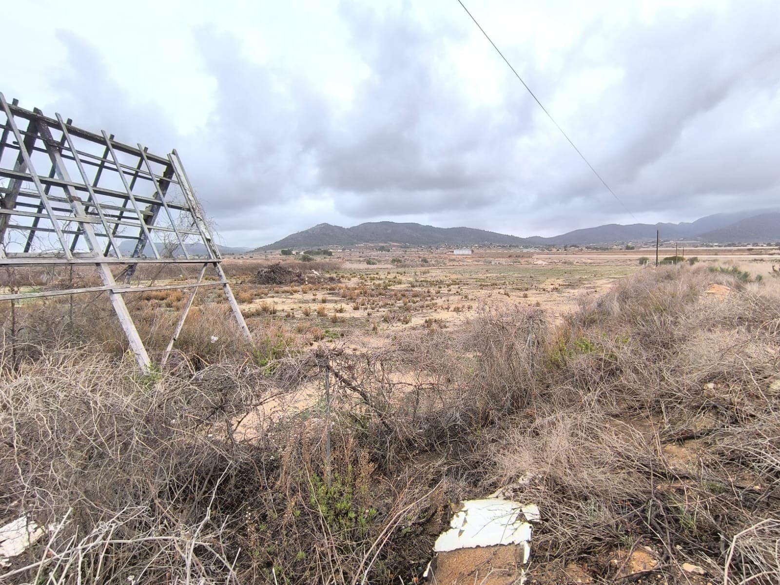 For sale: fully fenced parcel of roughly 11000 m2. The land, now empty, was used for storage of goods and can continue for that purpose, or can be turned into an orchard, a garden or serve as as investment. The parcel is flat, located by a busy road, equipped with irrigation water. Two access points, each with gate. About the areaLa Romana is a charming town known for its tranquil rural setting while being conveniently close to larger towns and the coast. Surrounded by vineyards and almond groves, it offers a relaxed lifestyle with a strong sense of community. Essential services, shops, restaurants, and schools are within easy reach, and Alicante airport is just a short drive away. This is an excellent opportunity to own a brand-new home in a peaceful yet well-connected location.About usWe have a large portfolio of properties in the Costa Blanca and Costa Calida areas, specialising in country properties, villas, fincas, building plots and design and build options in the Alicante and Murcia regions with a particular emphasis on Elda, Monovar, Pinoso, Sax, Villena, Aspe, Fortuna, Albacete and many more surrounding areas. We have been established since 2004 and have decades of experience between the team which we bring to bear to help you find and secure your new dream home. We help you every step of the way to make sure your purchase in Spain is safe and hassle free. We are not here to sell you a property, we are here to help you realise your dream and find what is right for you. With us you are in the safest hands. Contact us now to have a no obligation chat about how you too can realise your dreams.
