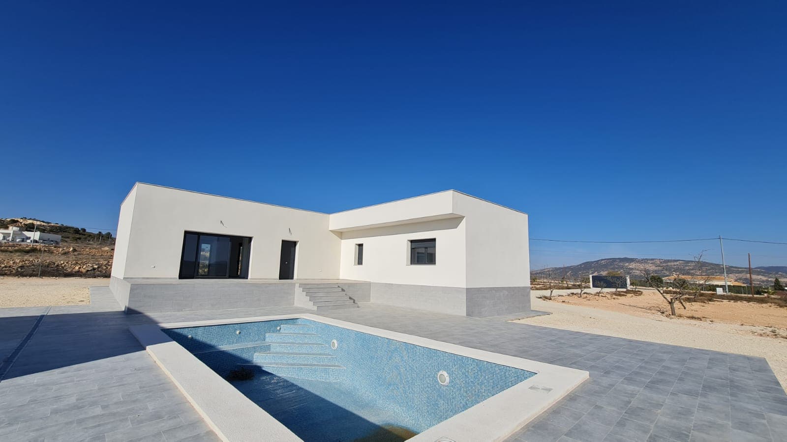 3 bed 2 villa currently under construction - located just 5 mins from pinoso town.  lovely modern design, very spacious design - can be customised depending on the stage of build.  **Key Features:**- **Open Plan Living Space:** The heart of the home is a spacious lounge that opens through large patio doors to the outdoor terrace, providing seamless indoor-outdoor living.- **Outdoor Living:** A large terrace overlooks a private swimming pool with expansive views of the surrounding vineyards, orchards, and mountains, ideal for relaxation and entertainment.- **Accommodation:** The villa includes a master bedroom with an en-suite bathroom equipped with a modern shower, two additional bedrooms, a main bathroom, and a large utility room for added convenience.**Location Benefits:**- **Community and Lifestyle:** Pinoso is known for its friendly community, local festivals, and a comfortable pace of life. The town offers essential amenities such as shopping, dining, and leisure facilities.- **Natural Surroundings:** The area is perfect for outdoor enthusiasts, with plenty of opportunities for hiking, cycling, and nature walks amidst scenic landscapes.- **Accessibility:** Pinoso maintains excellent road connections to major highways, with Alicante and its international airport only an hour's drive away, facilitating easy travel and access to urban centers.This property is ideal for those seeking a modern home in a serene rural setting with all conveniences nearby. The villa combines functionality with high-quality finishes, providing a comfortable and stylish living environment.