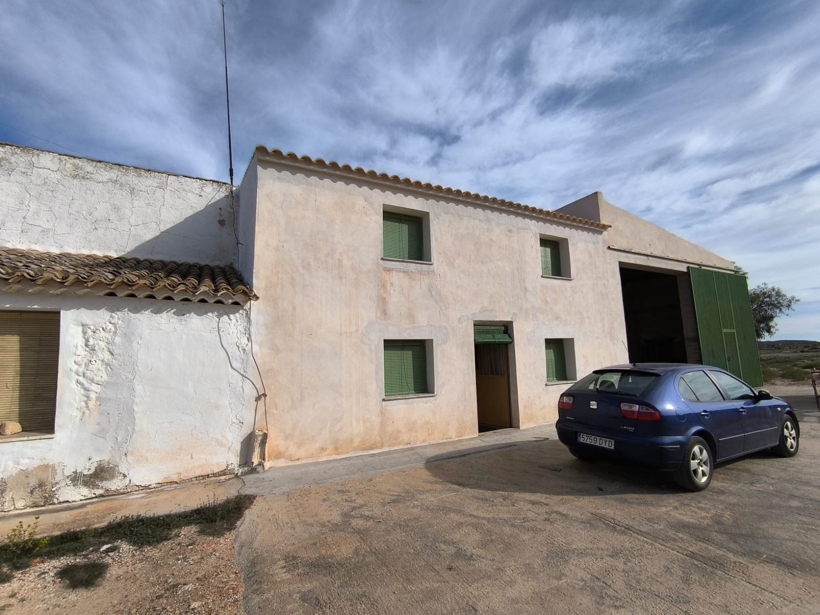Semi-detached country house located in the picturesque rural area of Yecla. Surrounded by almond and olive orchards, this property has a total built area of 386 m², with 258 m² in for residential use. The residential section features two floors, comprising seven spacious bedrooms, a salon equipped with a large traditional fireplace, a kitchen, a larder, and a bathroom.In addition to the living space, the property offers big garages and storage areas, a courtyard, and shared carports with the neighbouring semi-detached house. For your profit and agricultural ventures there is 7,300 m² vineyard, complete with an irrigation system and in full production.While the house is off-grid, it is equipped with functioning wiring and has access to mains irrigation water. Recent renovations include a new roof, façade, and few windows, although most rooms are in need of restoration. The house is sold furnished, but please note that agricultural machinery is not included in the sale.About the area: Yecla, located in the Murcia region, is known for its picturesque landscape, historic vineyards, and welcoming community. Just a short distance from the town center, this property enjoys rural tranquility while still being close to essential services like shops, restaurants, and schools. With its scenic surroundings and vibrant local culture, Yecla is an ideal location for those seeking a peaceful lifestyle or a profitable agriculture or tourism venture.About us: We have a large portfolio of properties in the Costa Blanca and Costa Calida areas, specialising in country properties, villas, fincas, building plots and design and build options in the Alicante and Murcia regions with a particular emphasis on Elda, Monovar, Pinoso, Sax, Villena, Aspe, Fortuna, Albacete and many more surrounding areas. We have been established since 2004 and have decades of experience between the team which we bring to bear to help you find and secure your new dream home. We help you every step of the way to make sure your purchase in Spain is safe and hassle free. We are not here to sell you a property, we are here to help you realise your dream and find what is right for you. With us you are in the safest hands. Contact us now to have a no obligation chat about how you too can realise your dreams.