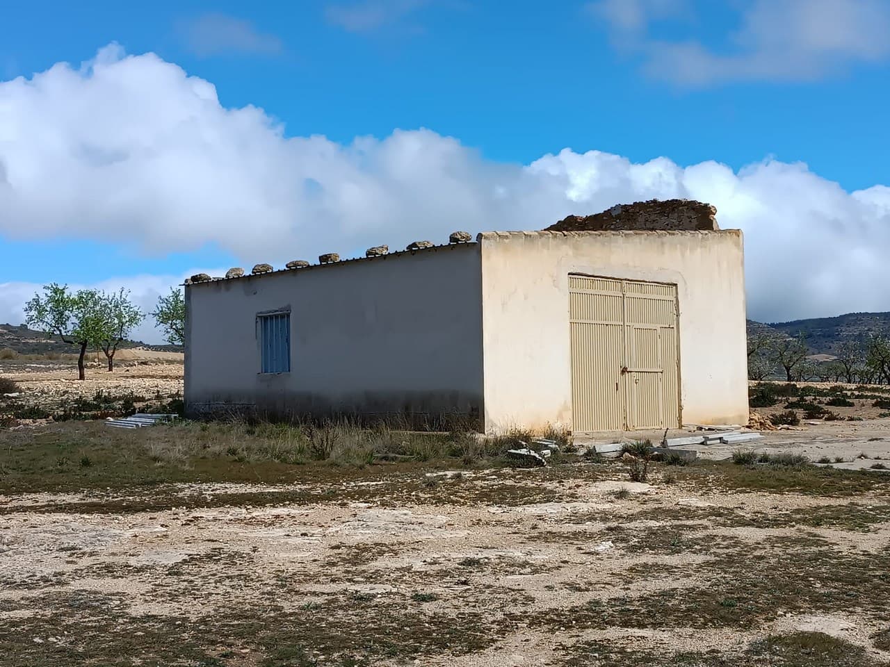Rural Plot with Agricultural Warehouse and Natural Spring – Between Yecla and CaudeteThis 11,000 m² rural property offers a great opportunity for those seeking a quiet, spacious plot surrounded by nature. The main country house has been demolished, but a well-maintained 75 m² agricultural warehouse remains on the land, complete with a galvanized metal roof. The plot is planted with almond trees and features several pine trees that offer natural shade. It is not fenced, providing an open, versatile space ideal for horses, caravans, motorhomes, or agricultural use.A key feature of the property is its own natural spring, which supplies irrigation water to the land—an asset for farming or keeping animals. Access to the plot is straightforward, with paved roads leading right to the entrance.About the AreaLocated just 12 km from Yecla and 8 km from Caudete, this plot sits in a quiet rural area with a strong agricultural tradition and panoramic views. Both towns offer all necessary services, including supermarkets, healthcare, restaurants, and schools. The area is known for its wine, almonds, and natural surroundings, making it ideal for those seeking a slower-paced lifestyle while remaining within easy reach of urban amenities.We have a large portfolio of properties in the Costa Blanca and Costa Calida areas, specialising in country properties, villas, fincas, building plots and design and build options in the Alicante and Murcia regions with a particular emphasis on Elda, Monovar, Pinoso, Sax, Villena, Aspe, Fortuna, Albacete and many more surrounding areas. We have been established since 2004 and have decades of experience between the team which we bring to bear to help you find and secure your new dream home. We help you every step of the way to make sure your purchase in Spain is safe and hassle free. We are not here to sell you a property, we are here to help you realise your dream and find what is right for you. With us you are in the safest hands. Contact us now to have a no obligation chat about how you too can realise your dreams.