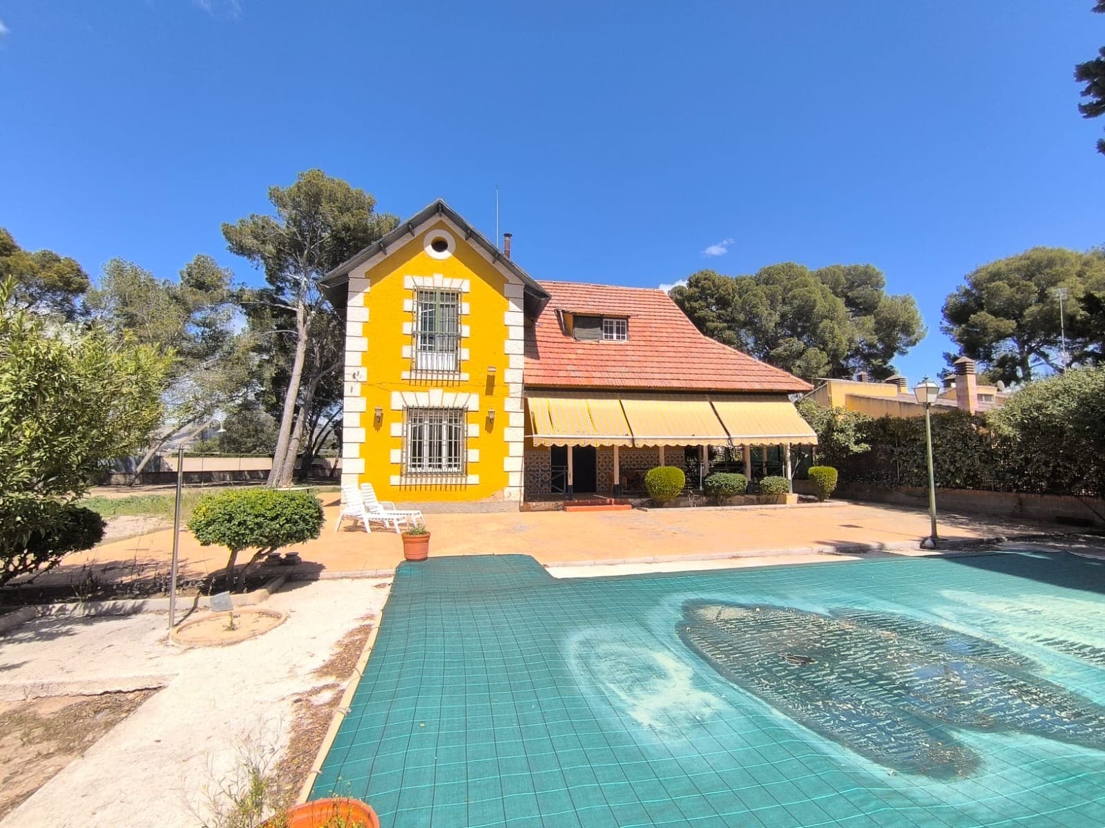 Beautiful Villa from 1910 in an exclusive location! Discover a unique opportunity to own a stunning villa, steeped in history and charm, located within a 10-minute walk from essential amenities including a hospital, school, shops, and the historic centre of Yecla. This property features two distinct houses, each offering its own potential and character.The first house is a well-maintained villa with two floors. It includes seven bedrooms (4 larger ones, 3 smaller ones), two bathrooms (one of them private for master's bedroom), a fully equipped kitchen, and multiple storage rooms. The villa also features two elegant salons, larger salon provides access to a covered terrace. The interior is adorned with an old stylish staircase and design furniture, reflecting the villa's unique style and soul.The second house presents a restoration opportunity. While the construction is solid, the interior awaits your creative vision to transform it into a personalized space. It includes a garage and various storage rooms.The garden of nearly 5000 m2 is beautifully shaded by mature pine trees and is fully fenced for privacy. An electric gate provides convenient access, and while most areas of the garden are secluded, some sections offer picturesque views of Yecla's historic centre.The property also features two swimming pools: a modern rectangular pool situated just in front of the house, and a circular pool that is in need of restoration, providing further potential for leisure and relaxation.This villa is connected to essential utilities, including electricity, drinking water, and sewage, making it a perfect blend of historical charm and modern convenience. Don't miss the chance to own this exceptional property!About the area: Yecla is renowned for its wine production, historical landmarks, and vibrant local culture. The surrounding natural landscapes provide opportunities for outdoor activities, while the town itself offers all necessary services, including schools, shops, and restaurants. This property combines the tranquility of countryside living with easy access to modern amenities.About us: We have a large portfolio of properties in the Costa Blanca and Costa Calida areas, specialising in country properties, villas, fincas, building plots and design and build options in the Alicante and Murcia regions with a particular emphasis on Elda, Monovar, Pinoso, Sax, Villena, Aspe, Fortuna, Albacete and many more surrounding areas. We have been established since 2004 and have decades of experience between the team which we bring to bear to help you find and secure your new dream home. We help you every step of the way to make sure your purchase in Spain is safe and hassle free. We are not here to sell you a property, we are here to help you realise your dream and find what is right for you. With us you are in the safest hands. Contact us now to have a no obligation chat about how you too can realise your dreams.