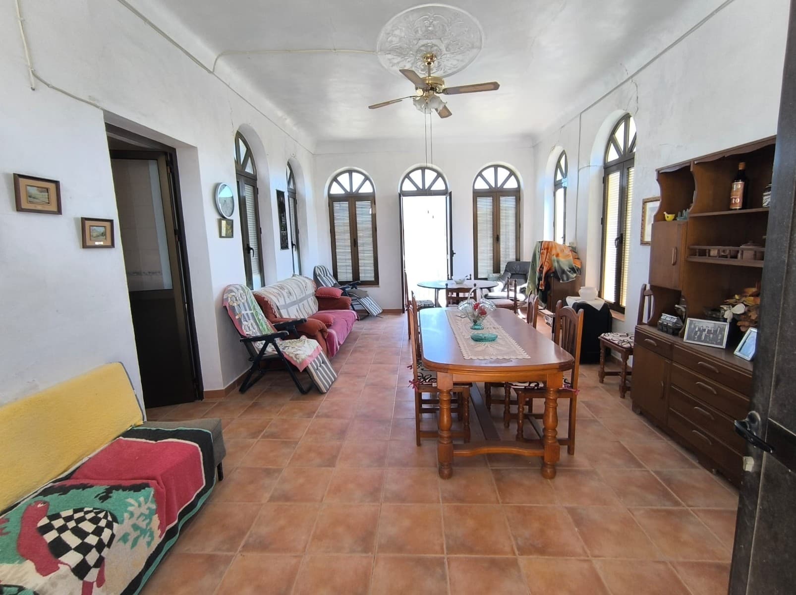 If you've been longing for a peaceful escape where nature, charm, and convenience come together in perfect harmony — look no further.This unique traditional country home offers everything you could ever want: space, character, privacy, and those breathtaking views that stop you in your tracks… all just a 5-minute walk from the town centre.Set on a small, paved country lane and surrounded by greenery, this semi-detached property offers total peace and privacy — with no neighbours living next door — yet without the feeling of being isolated. Built in the timeless style of rural Spanish homes, with thick stone walls that naturally regulate temperature, this home is filled with warmth, soul, and authenticity. The property features two independent entrances. One brings you into the heart of the home: a bright, open-plan living room flooded with natural light from large windows that open onto a balcony with panoramic countryside views — ideal for morning coffees or evening sunsets in total serenity.From the living room, step into a fully functional kitchen that connects directly to the lush garden, offering the perfect blend of indoor and outdoor living. On this floor, you'll also find a full bathroom, and a second entrance leads to a grand main hallway, spacious and inviting — the kind of entryway that immediately says “this is home." From here, discover a second cosy lounge, a bedroom, and two additional small rooms ideal for pantry storage, food supplies, a wine cellar, or creative workspace. Head up the stairs to find a large, light-filled bedroom, plus a wide hallway with generous windows that fill the space with sunlight all day long. This leads to a second hallway with several more rooms, offering endless potential for guest bedrooms, a home office, or even a personal wellness retreat.The property also boasts a large plot of land with more than enough space to build a beautiful swimming pool with a barbecue area — perfect for entertaining guests, enjoying sunny Mediterranean afternoons, or simply relaxing in your own private oasis. Imagine waking up to birdsong, sipping coffee while gazing out over rolling hills, then strolling into town for fresh bread or a café con leche — all without ever needing a car.This property is a rare gem:Just 500 meters from MonóvarSurrounded by nature and peaceStunning views from every angleFilled with traditional charm and natural lightMove-in ready, yet full of potential to make it your ownIn addition to the existing property, there is also the option to purchase a generous 14,000 m² plot of land. This expansive area offers plenty of space for building a new home, providing endless possibilities to expand your living space or create a custom property tailored to your needs.Don't miss out on the chance to combine this charming country house with a significant parcel of land!Opportunities like this don't come around often. Whether you're looking for a full-time home, a weekend escape, or a rental investment with rustic appeal — this house has the character, location, and soul to become something truly special.We have a large portfolio of properties in the Costa Blanca and Costa Calida areas, specialising in country properties, villas, fincas, building plots and design and build options in the Alicante and Murcia regions with a particular emphasis on Elda, Monovar, Pinoso, Sax, Villena, Aspe, Fortuna, Albacete and many more surrounding areas. We have been established since 2004 and have decades of experience between the team which we bring to bear to help you find and secure your new dream home. We help you every step of the way to make sure your purchase in Spain is safe and hassle free. We are not here to sell you a property, we are here to help you realise your dream and find what is right for you. With us you are in the safest hands. Contact us now to have a no obligation chat about how you too can realise your dreams.