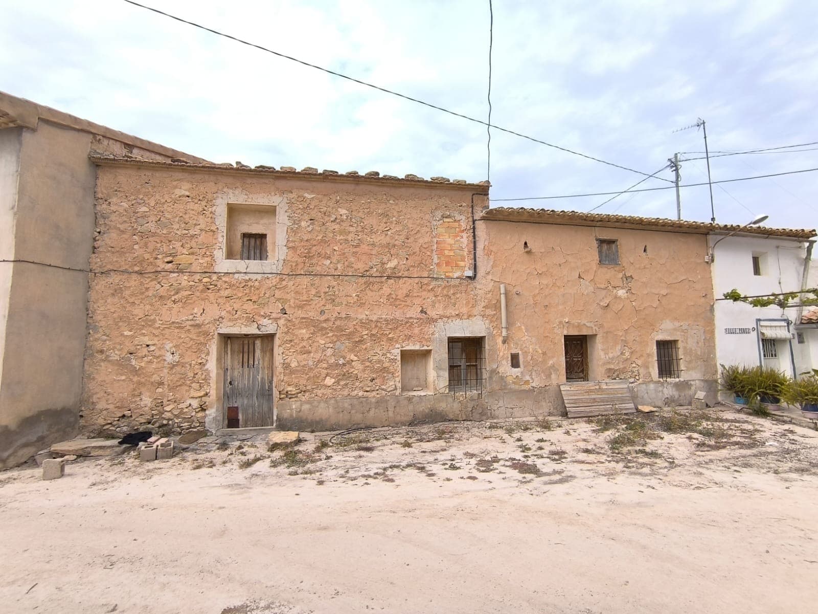 Discover an opportunity to own a several hundred year old cave house. Nestled in a serene hamlet, located just a 20-minute drive from Pinoso and 25 minutes from Jumilla, offering a tranquil environment with stunning views and ample hiking opportunities.The property features a two-story exterior construction. The upper floor comprises two spacious rooms, while the ground floor seamlessly transitions into an ancient cave with numerous rooms with hidden gems, such as old fireplace. The cave maintains a consistent climate, ensuring comfort without high humidity levels. While the exterior construction is solid, the façade and interior require renovation to uncover their potential. Additionally, the property includes a small outdoor garage and a piece of land, serving as a garden. The house lacks plumbing, but has a grid water connection.This property is not for everyone; however, it holds the potential to be transformed into a truly unique home or a charming bed and breakfast. If you are looking for a distinctive living experience or an investment opportunity, this antique cave house could be the perfect fit.About the area: Jumilla is a charming town renowned for its scenic vineyards, and vibrant local culture. Known primarily for its award-winning wines, this picturesque town offers a perfect blend of traditional Spanish character and modern living. With its historic landmarks, bustling market squares, and beautiful countryside, Jumilla provides an ideal setting for those seeking a peaceful yet vibrant lifestyle in province Murcia, 80 minutes from Costa Blanca.About us: We have a large portfolio of properties in the Costa Blanca and Costa Calida areas, specialising in country properties, villas, fincas, building plots and design and build options in the Alicante and Murcia regions with a particular emphasis on Elda, Monovar, Pinoso, Sax, Villena, Aspe, Fortuna, Albacete and many more surrounding areas. We have been established since 2004 and have decades of experience between the team which we bring to bear to help you find and secure your new dream home. We help you every step of the way to make sure your purchase in Spain is safe and hassle free. We are not here to sell you a property, we are here to help you realise your dream and find what is right for you. With us you are in the safest hands. Contact us now to have a no obligation chat about how you too can realise your dreams.