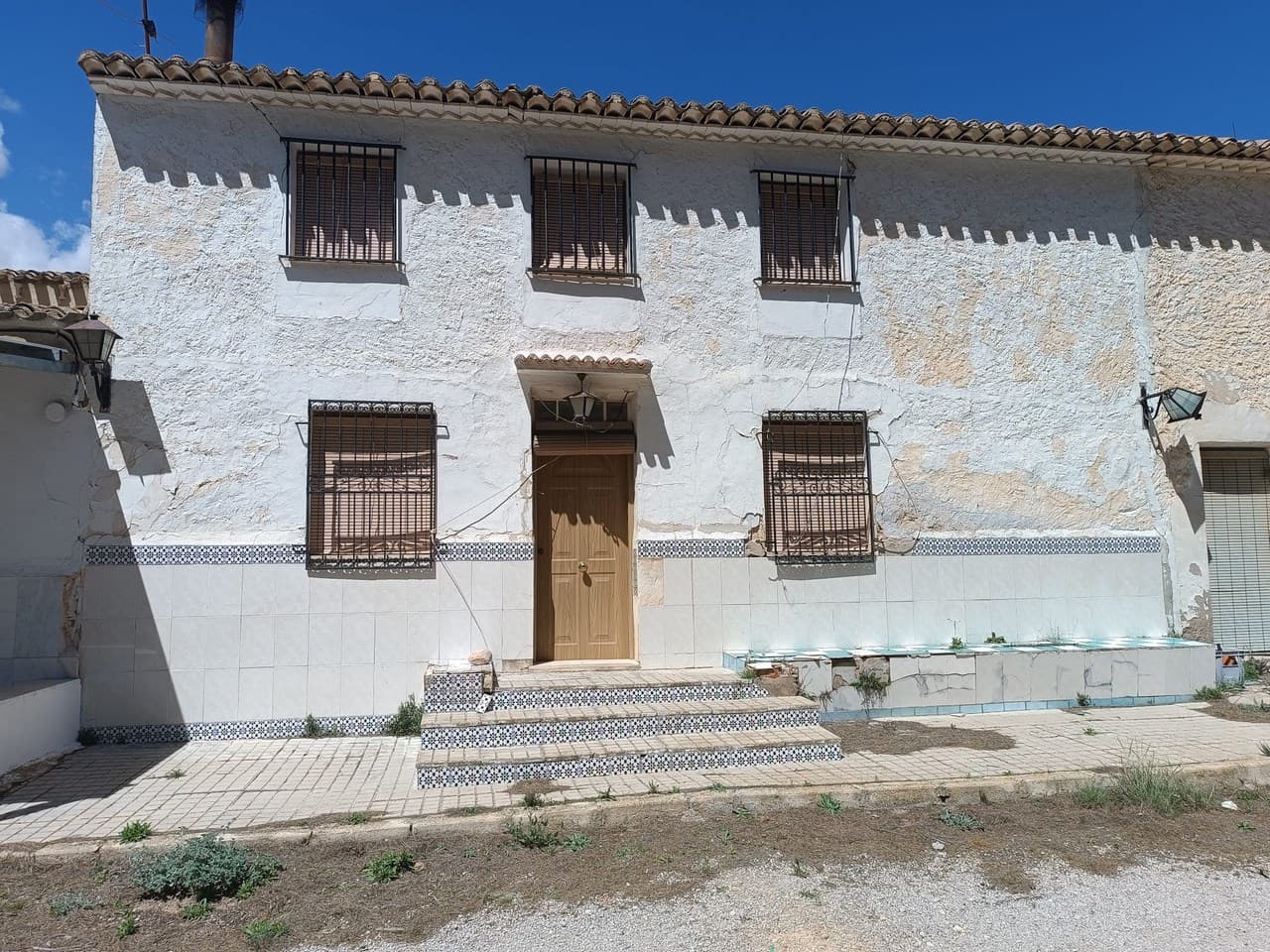 We present you this attached country house for bargain price! The property features an easy-to-access, spacious country house of 150 m² across two floors, located just 7 km from Yecla. The house boasts 6 bedrooms, a bathroom, and a cosy lounge/dining room with an integrated kitchen, complete with a fireplace for added warmth and ambiance. The property needs some restoration work, is attached to neighbouring houses from both sides and is located very close to a main road, which creates some noise. With the house comes a generous land of 130,000 m², spread across multiple parcels and terrains nearby, the land is not compact (see pictures, the land included is marked with yellow).The neighbouring house - 41045b-PB - which shares one wall, courtyard and water deposit with this property, is for sale as well. For combined price of 199.000 €, you could buy both properties at once to gain almost 400,000 m² of land: 41045-PBWater supply is ensured through a private well and water deposit. The property is not connected to mains electricity. While in need of a solar system and new wiring, it offers an opportunity for off-grid living. Nestled in a picturesque natural setting, the house provides panoramic views. Thanks to its location and expansive land, this property is particularly suited for equestrian enthusiasts and is ideal for placing olive, almond, pistachio, or vineyard plantations. Don't miss the chance to own this versatile and serene country retreat.About the area: Yecla is renowned for its wine production, historical landmarks, and vibrant local culture. The surrounding natural landscapes provide opportunities for outdoor activities, while the town itself offers all necessary services, including schools, shops, and restaurants. This property combines the tranquility of countryside living with easy access to modern amenities.About us: We have a large portfolio of properties in the Costa Blanca and Costa Calida areas, specialising in country properties, villas, fincas, building plots and design and build options in the Alicante and Murcia regions with a particular emphasis on Elda, Monovar, Pinoso, Sax, Villena, Aspe, Fortuna, Albacete and many more surrounding areas. We have been established since 2004 and have decades of experience between the team which we bring to bear to help you find and secure your new dream home. We help you every step of the way to make sure your purchase in Spain is safe and hassle free. We are not here to sell you a property, we are here to help you realise your dream and find what is right for you. With us you are in the safest hands. Contact us now to have a no obligation chat about how you too can realise your dreams.