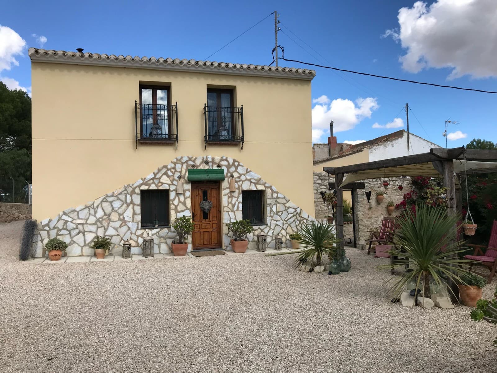 Beautiful luxurious renovated spacious house with 5 bedrooms and 2 bathrooms located in a charming hamlet just outside La Romaneta. Athough this is an attached house, you can still enjoy your privacy in the south-facing garden and swimming pool, having a barbecue in the outdoor patio and overlooking fields and hills. The surroundings are breathtaking: nature, peace and space. The friendly neighbors contribute to a welcome feeling, a unique place to relax. This charming house has been beautifully restored with only the best materials, has a new roof but kept its local character intact. The house also has a garage and a barn. This could be converted into a guest house or you can leave it as is and use it for storage or hold a party in it, sheltered from a possible rain shower. We have a large portfolio of properties in the Costa Blanca and Costa Calida areas, specialising in country properties, villas, fincas, building plots and design and build options in the Alicante and Murcia regions with a particular emphasis on Elda, Monovar, Pinoso, Sax, Villena, Aspe, Fortuna, Albacete and many more surrounding areas. We have been established since 2004 and have decades of experience between the team which we bring to bear to help you find and secure your new dream home. We help you every step of the way to make sure your purchase in Spain is safe and hassle free. We are not here to sell you a property, we are here to help you realise your dream and find what is right for you. With us you are in the safest hands. Contact us now to have a no obligation chat about how you too can realise your dreams.