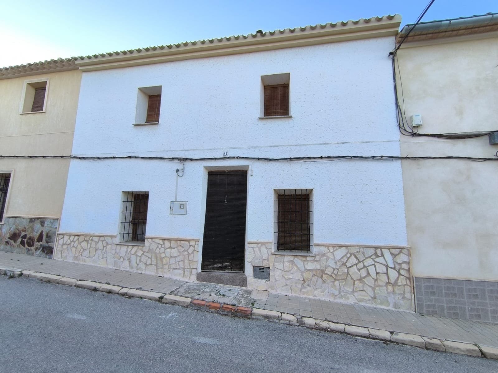 This townhouse in the centre of Raspay offers a unique opportunity for those looking to invest in a partially finished house and turn it into their dream house. The property spans 380 m², of which 280 m² is dedicated to the house itself, over two floors. The living space features 7 bedrooms, a cosy salon with a fireplace, a kitchen, and a bathroom. Outside, we can find a private patio with covered BBQ area, the first floor offers a private terrace. The floors and roofs are new, the salon, two bedrooms and bathroom are completed in traditional Spanish style and are ready for immediate use, the rest of the interior is to finish or to reform. In front of the house, there is a 100 m² garage equipped with an old stove and ample space for storage or other uses. The property is connected to essential utilities, including electricity, drinking water, and sewage, with optic fiber available in the area. Notably, the kitchen conceals an old rainwater reservoir beneath it.While this house requires significant renovation, it presents a great opportunity at a bargain price for those willing to invest in its potential.About the area: Nestled in the quaint settlement of Raspay, the surrounding area offers easy parking, a serene Spanish countryside atmosphere, and ample opportunities for hiking and relaxation. Don't miss this opportunity to own a piece of paradise for very favourable price.About us: We have a large portfolio of properties in the Costa Blanca and Costa Calida areas, specialising in country properties, villas, fincas, building plots and design and build options in the Alicante and Murcia regions with a particular emphasis on Elda, Monovar, Pinoso, Sax, Villena, Aspe, Fortuna, Albacete and many more surrounding areas. We have been established since 2004 and have decades of experience between the team which we bring to bear to help you find and secure your new dream home. We help you every step of the way to make sure your purchase in Spain is safe and hassle free. We are not here to sell you a property, we are here to help you realise your dream and find what is right for you. With us you are in the safest hands. Contact us now to have a no obligation chat about how you too can realise your dreams.
