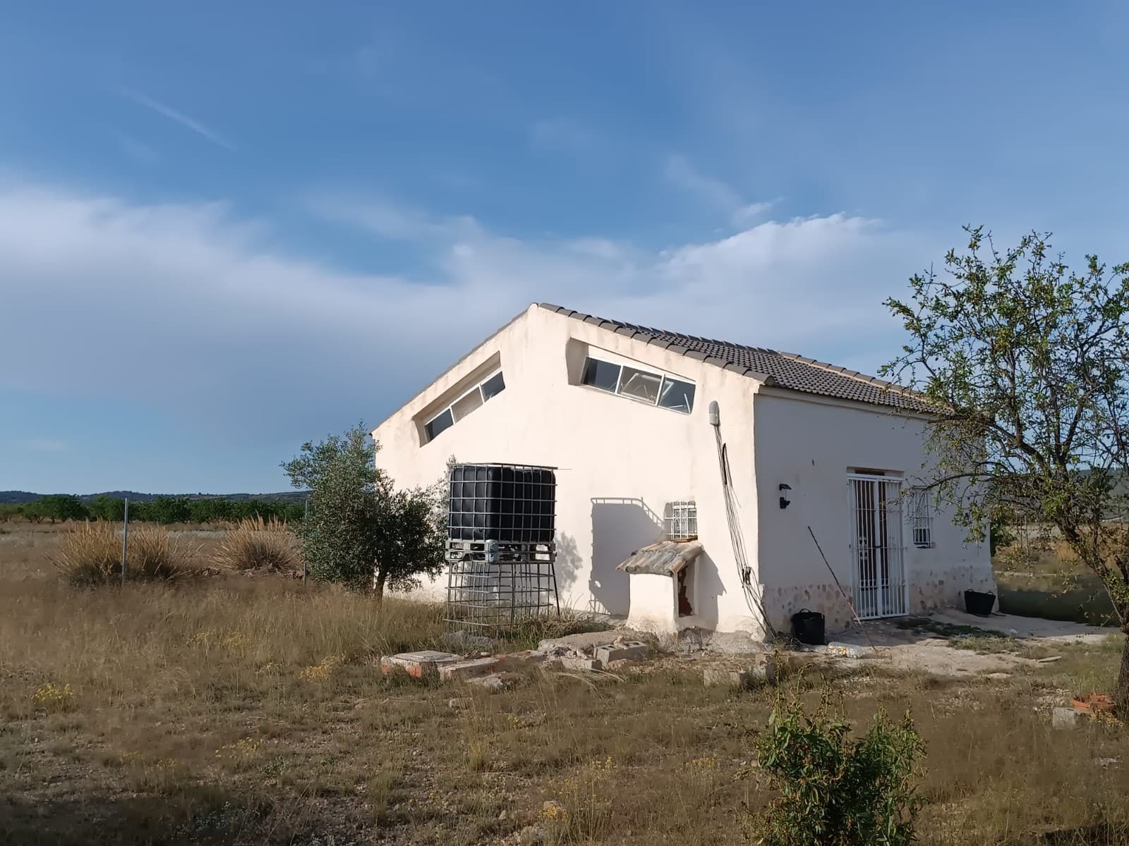 Are you looking for an viable investment? Agricultural adventure? Or just a huge, private property, where you could do anything you'd like to? All of that for less than 100k? You've come to the right place! A little country house of 45 m2, totally reformed, with spaces for a bathroom and a salon/kitchen/bedroom, sitting on a fenced garden of 16000 m2, equipped with a covered car port and a storage house. Please note that the building is officially not a house, and it can't be legalized as such.Furthermore, there are 50.000 m2 of century old olive orchards, 20.000 m2 of almonds and 50.000 m2 of field for cereal cultivation. All land and trees are cared of and in full production. The property is located in calm, rural area, 10 km from Yecla.For 98.000 €, the property offers price of less than 1€ per m2, and a little house on top of that. Don't hesitate and contact us to arrange a viewing!About the area: Yecla is renowned for its wine production, historical landmarks, and vibrant local culture. The surrounding natural landscapes provide opportunities for outdoor activities, while the town itself offers all necessary services, including schools, shops, and restaurants. This property combines the tranquility of countryside living with easy access to modern amenities.About us: We have a large portfolio of properties in the Costa Blanca and Costa Calida areas, specialising in country properties, villas, fincas, building plots and design and build options in the Alicante and Murcia regions with a particular emphasis on Elda, Monovar, Pinoso, Sax, Villena, Aspe, Fortuna, Albacete and many more surrounding areas. We have been established since 2004 and have decades of experience between the team which we bring to bear to help you find and secure your new dream home. We help you every step of the way to make sure your purchase in Spain is safe and hassle free. We are not here to sell you a property, we are here to help you realise your dream and find what is right for you. With us you are in the safest hands. Contact us now to have a no obligation chat about how you too can realise your dreams.