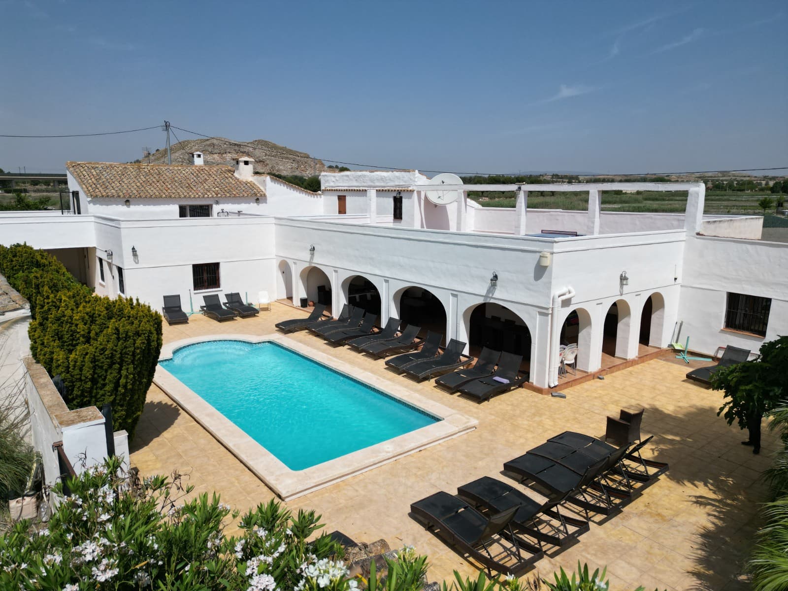 Fully Renovated Country Mansion with Tourist License and 8 Independent Apartments in Villena, AlicanteSet just 3 km from the historic city of Villena, this impressive country estate offers a unique blend of charm, privacy, and business potential. Once a grand farmhouse, the property has been fully renovated and converted into a high-quality rural tourism venue with 8 self-contained apartments and a tourist license in place. Located on a 14,000 m² partly fenced plot with electric gated entry, this estate offers an ideal setting for large families, holiday rentals, wellness retreats, or business events.The property includes 13 bedrooms and 12 bathrooms, distributed across 8 private apartments, each with its own entrance, kitchen, living area, and bathroom. Accommodation ranges from studio units to spacious three-bedroom apartments, all equipped with Smart TVs, BluRay players, and WiFi. Central heating is installed throughout.In addition to the individual living spaces, there are multiple communal areas including: A large swimming pool with sunbathing terraces Two purpose-built BBQ zones with food prep areas Gardens with fruit trees and shaded spots for relaxation A laundry room with WC A large indoor dining/conference room with seating for 26 Private off-road parking area From the upper terraces, guests can enjoy breathtaking views over the valley and toward Villena's castle.Apartment Summary: Apartment 1: 2 bedrooms, large living space with log burner Apartment 2: Studio with en-suite and kitchenette Apartment 3: 1 double bedroom, shower room, kitchen and lounge Apartment 4: 2 bedrooms, 2 bathrooms, large kitchen and lounge, private balcony Apartment 5: 3 bedrooms including a grand suite, 3 bathrooms, open-plan kitchen/dining/lounge Apartment 6: 2 bedrooms (1 double, 1 single), 2 bathrooms Apartment 7 & 8: 1 double bedroom each with en-suite and living space About the Area: Villena is a picturesque medieval city rich in culture, history, and architecture. The town features two castles, beautiful churches, local markets, museums, and vibrant squares. It offers a full range of services including restaurants, bars, shops, supermarkets, and schools. Alicante airport is only an hour away, and Villena's high-speed rail station provides fast access to Alicante (35 minutes) and Madrid (2.5 hours). The surrounding landscape is perfect for nature lovers, with scenic trails, vineyards, and mountain views.This is a rare opportunity to acquire a fully equipped hospitality business in an established tourist destination with excellent infrastructure and long-term potential. Contact us today to arrange a viewing.We have a large portfolio of properties in the Costa Blanca and Costa Calida areas, specialising in country properties, villas, fincas, building plots and design and build options in the Alicante and Murcia regions with a particular emphasis on Elda, Monovar, Pinoso, Sax, Villena, Aspe, Fortuna, Albacete and many more surrounding areas. We have been established since 2004 and have decades of experience between the team which we bring to bear to help you find and secure your new dream home. We help you every step of the way to make sure your purchase in Spain is safe and hassle free. We are not here to sell you a property, we are here to help you realise your dream and find what is right for you. With us you are in the safest hands. Contact us now to have a no obligation chat about how you too can realise your dreams.